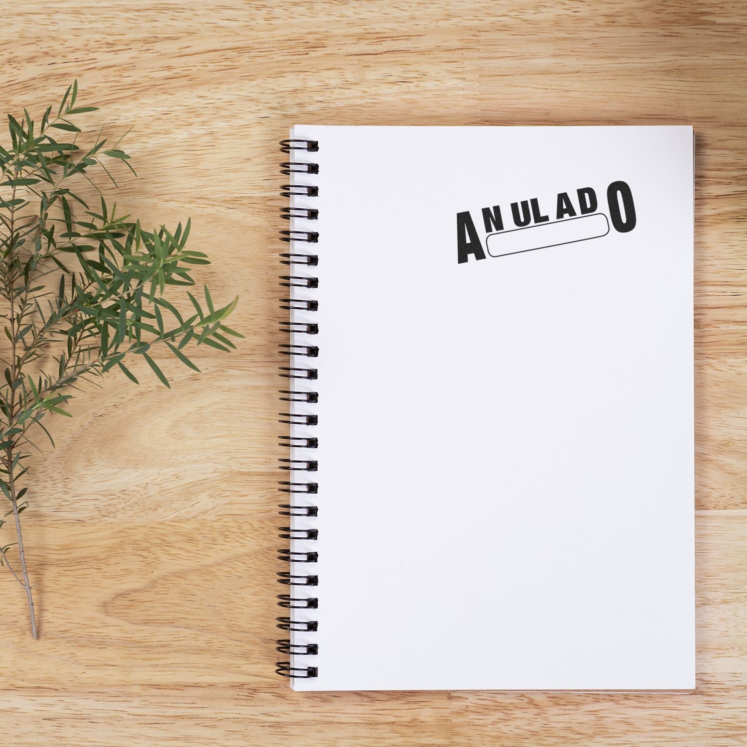 Voided ANULADO stamp on spiral notebook on wooden desk, concept of canceled documents, invoices, and administrative paperwork rejection