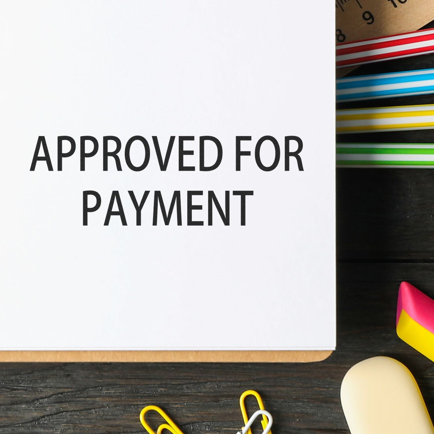 Approved for payment stamp on paperwork over desk, signaling invoice authorization for accounts payable and payment processing.