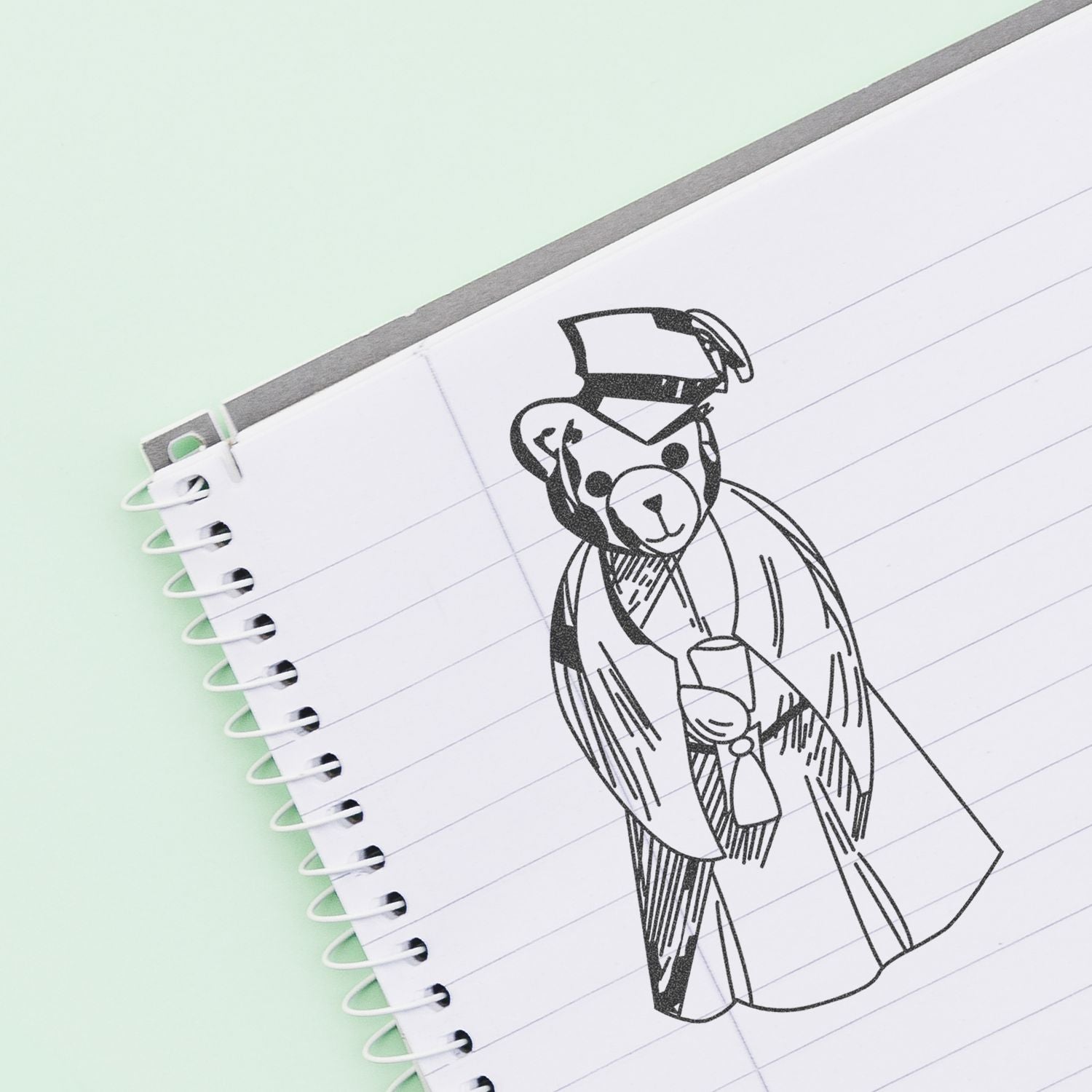 Notebook with cute teddy bear doodle on lined paper, simple sketch illustration on a pastel background.