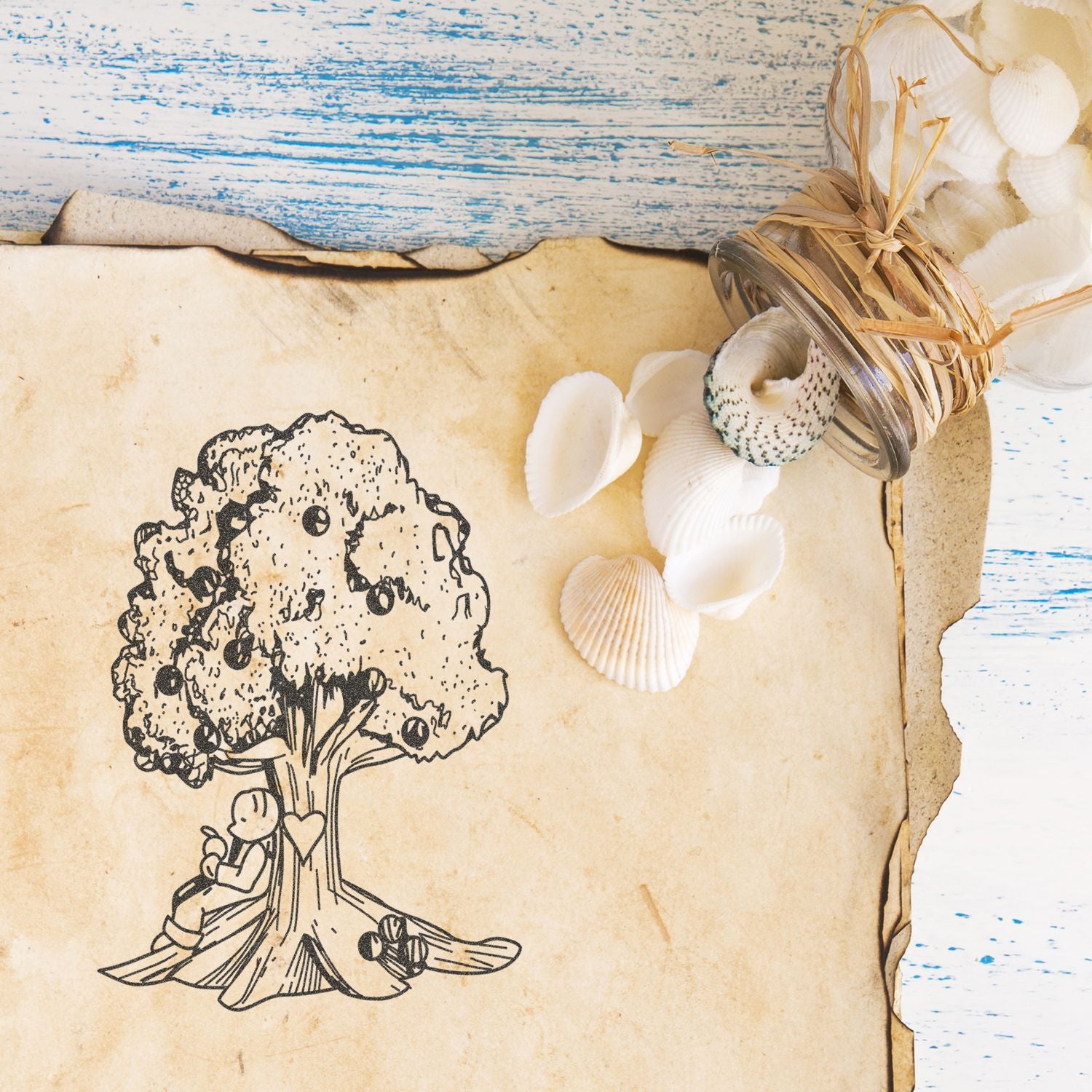 Vintage beach-themed scrapbook paper with tree illustration, seashell craft accents, and rustic distressed wood background.