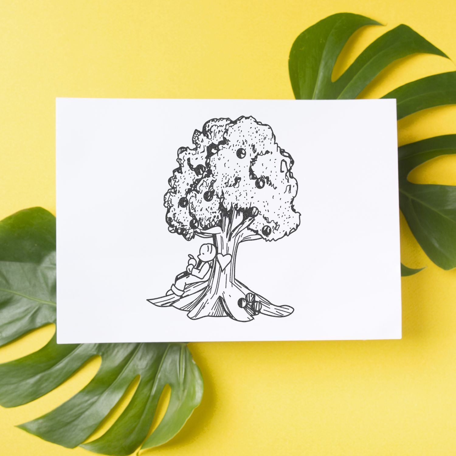 Minimalist tree illustration on a white card with tropical green leaves on a yellow background.
