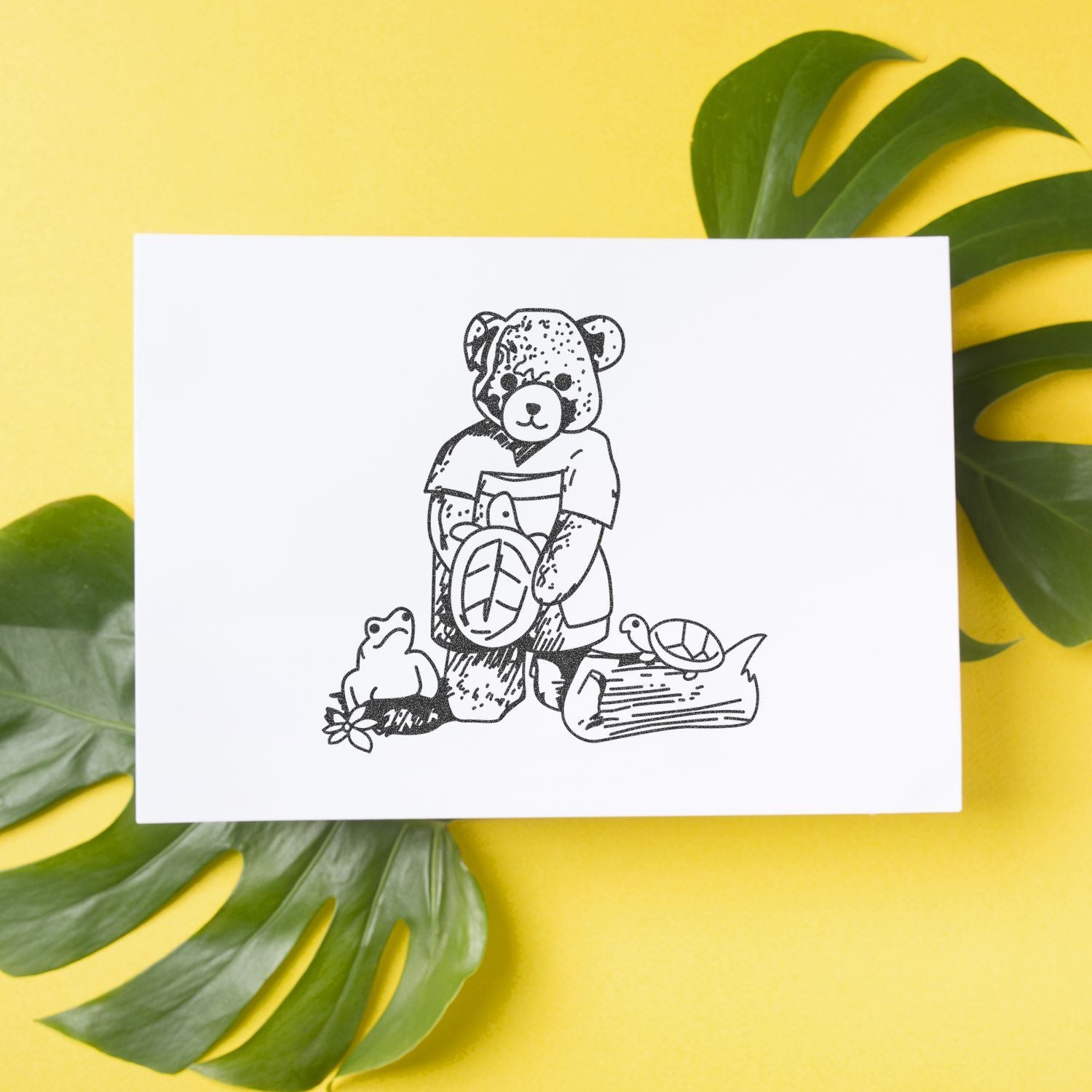 Cute illustrated greeting card with teddy bear, frog, and turtle on a yellow background with tropical green leaves.
