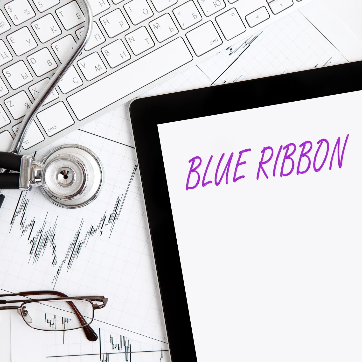 Blue ribbon awareness concept with tablet, stethoscope, glasses, keyboard, and medical chart.