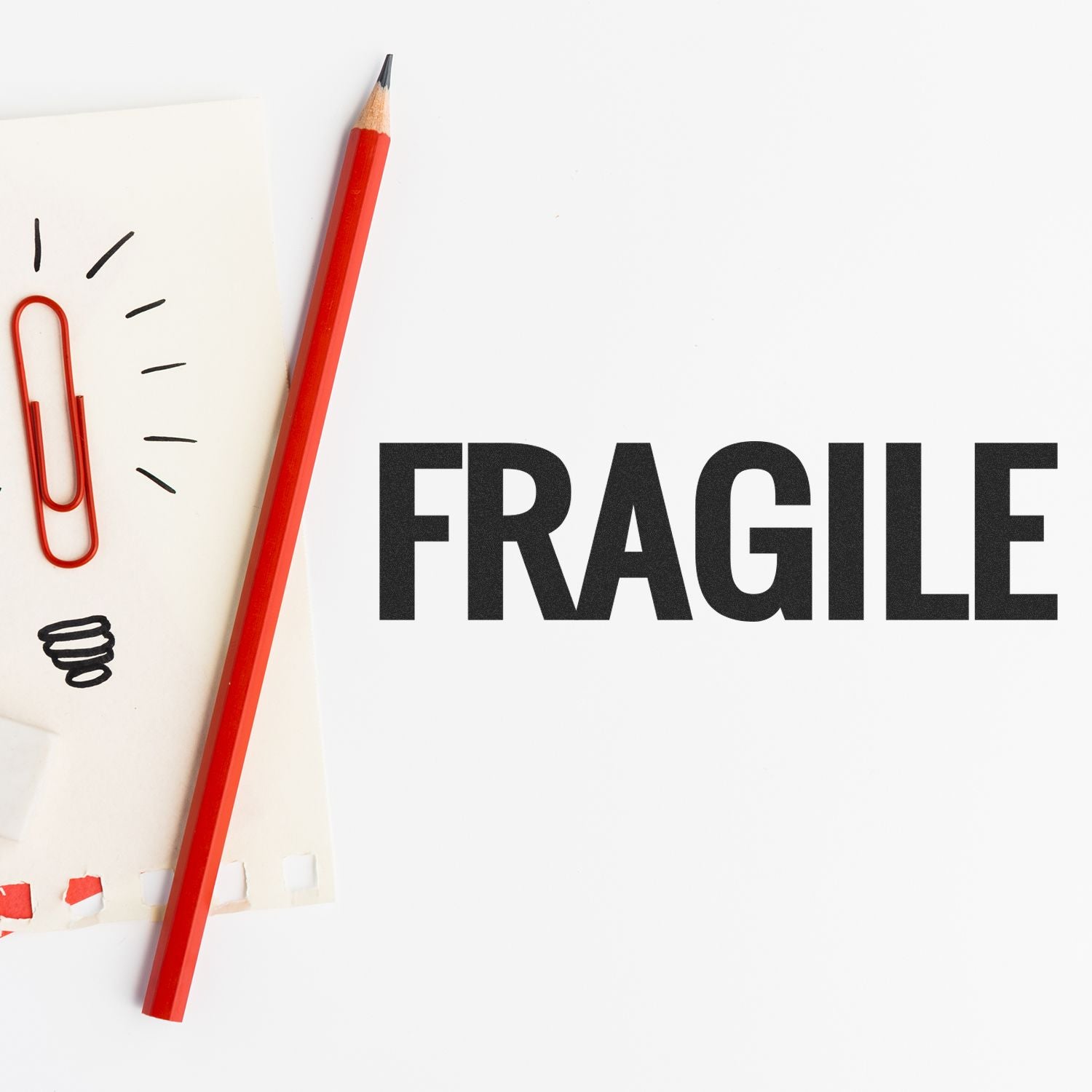 Fragile warning with red pencil on paper, highlighting careful handling of breakable items for shipping and logistics safety.