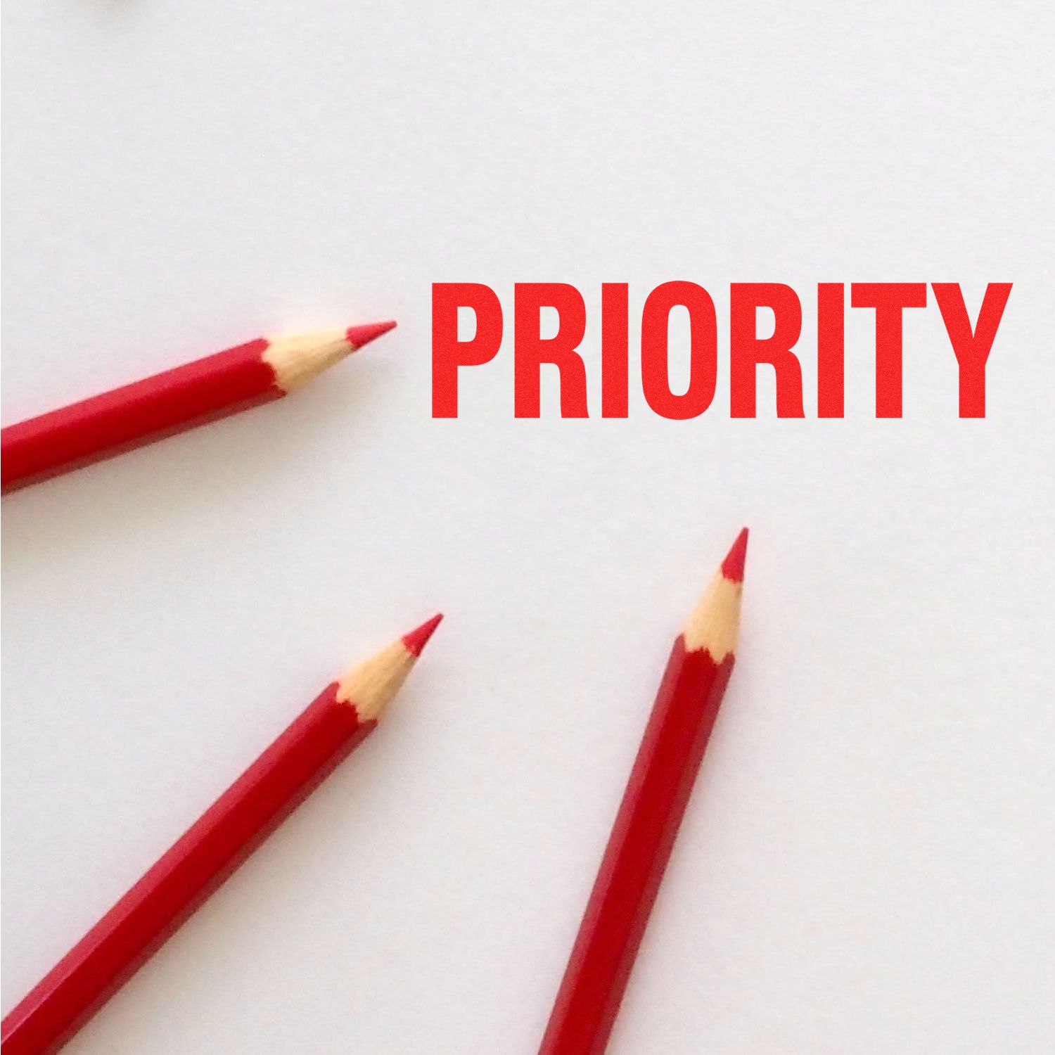 Red pencils with the word Priority on a white background, symbolizing focus, task management, and business priorities.