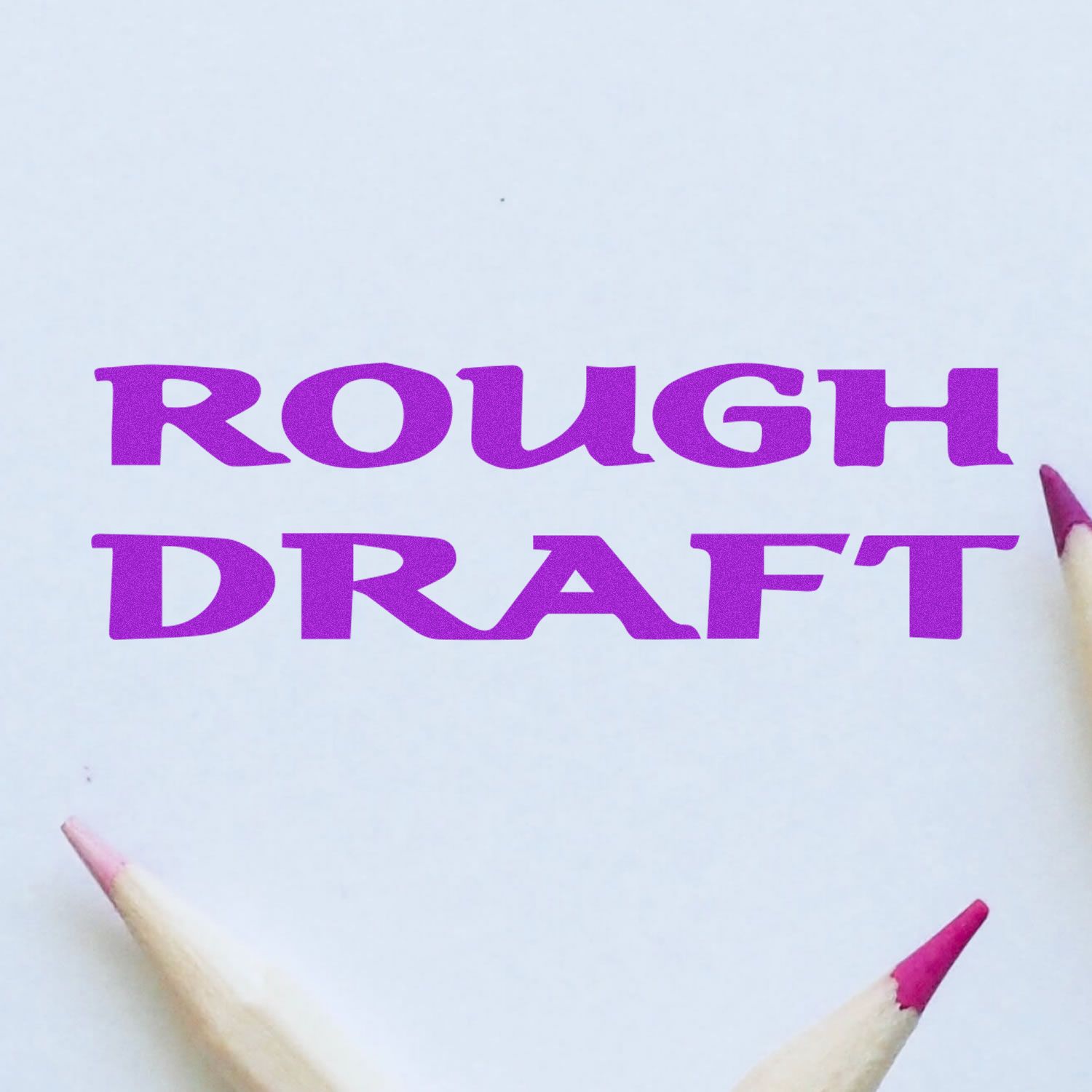 Purple ROUGH DRAFT text on white paper with colored pencils, concept for creative writing and sketching.