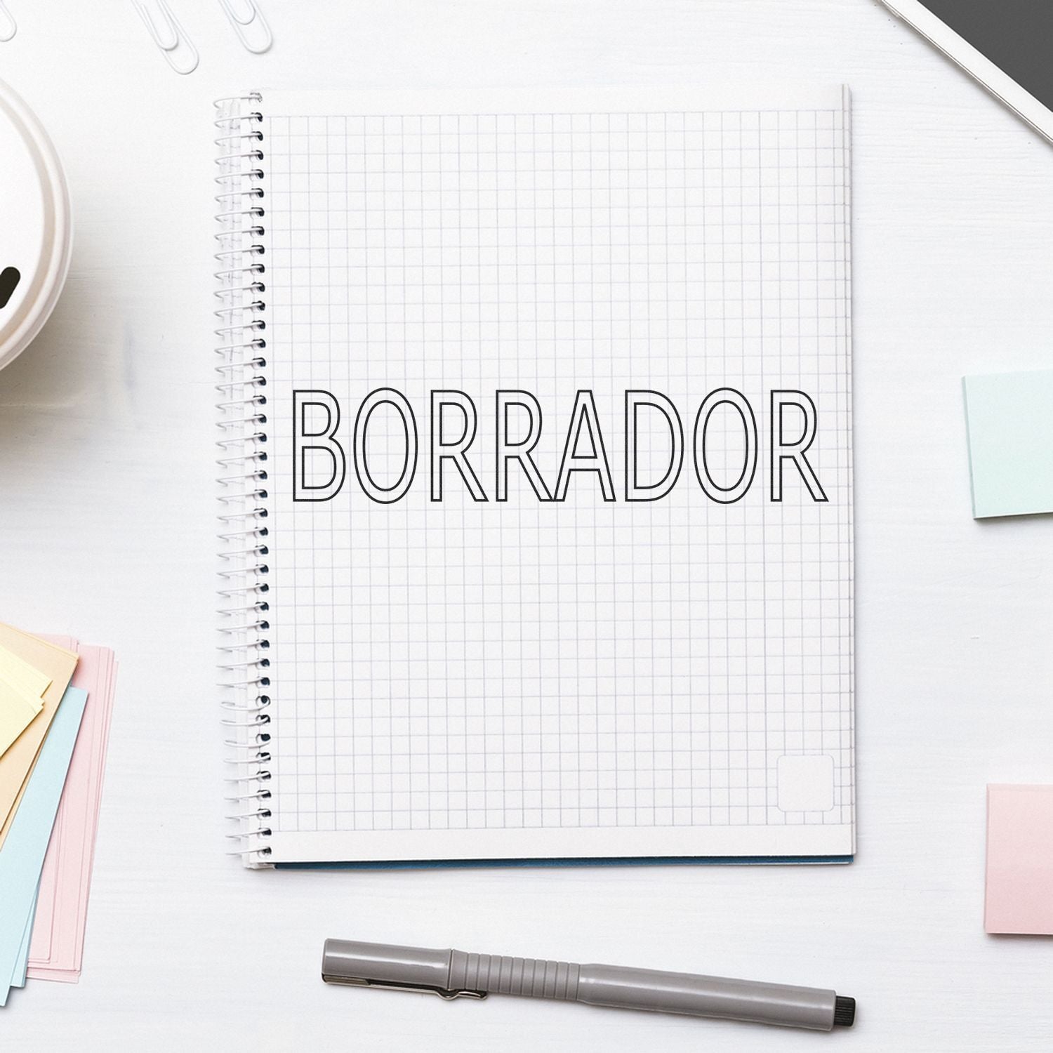 Spanish draft planning page on a grid notebook labeled BORRADOR, showing writing notes for concepts, projects and proposal development.