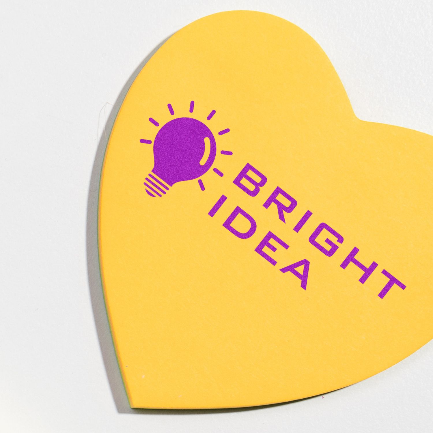 Yellow heart-shaped card with purple sun icon and Brighter Day lettering for inspirational, sunshine-themed branding.