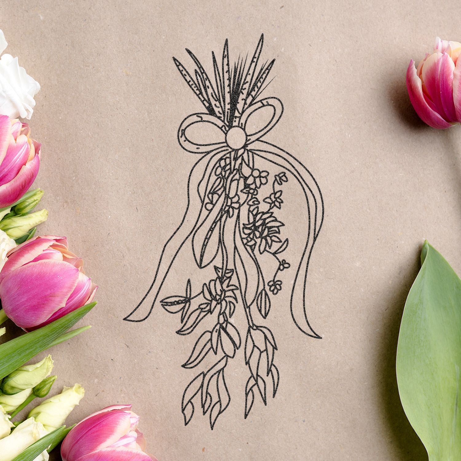 Elegant floral line art bouquet on kraft paper surrounded by pink tulips and greenery, rustic botanical wedding design.