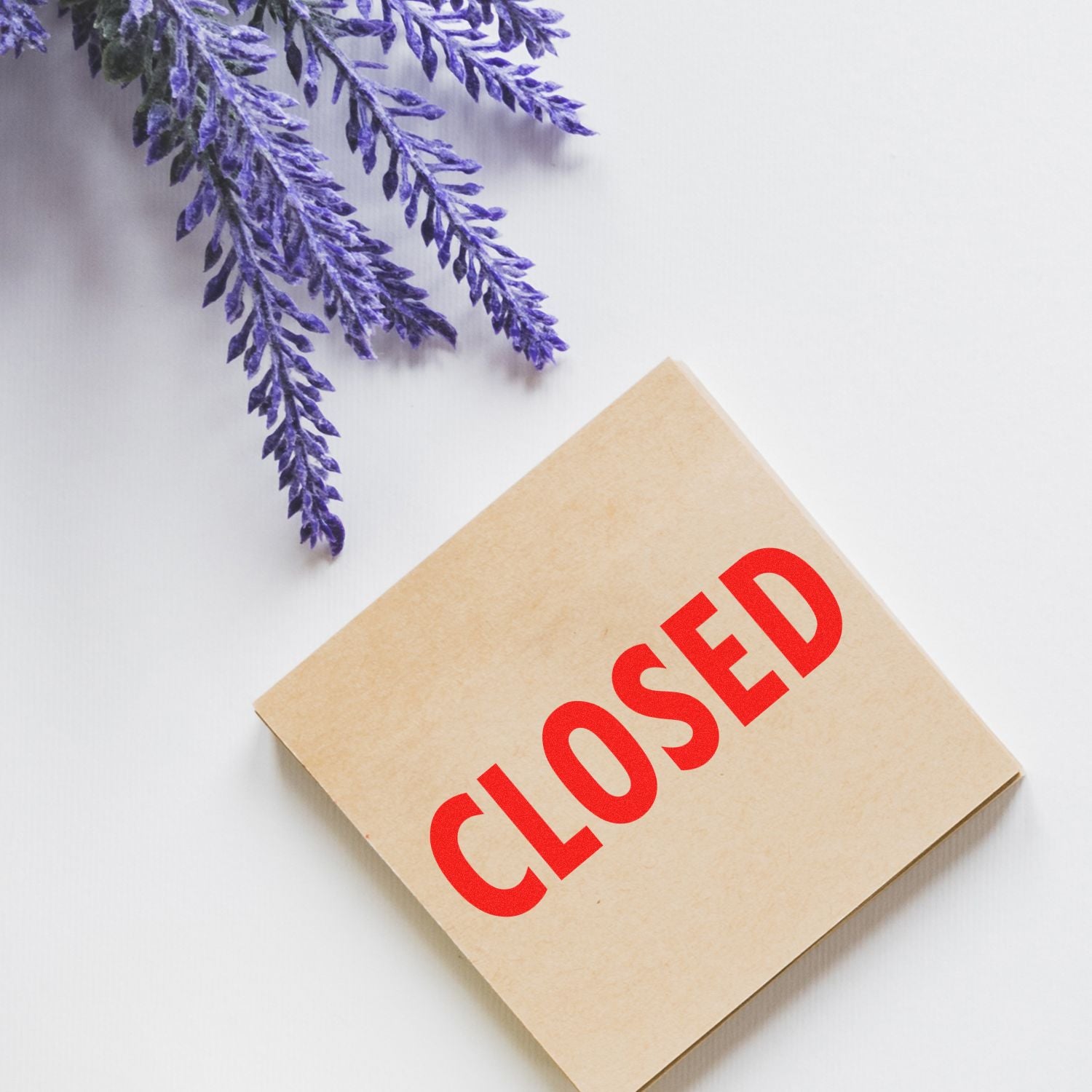 Closed sign on a beige box with purple lavender flowers on a white background.