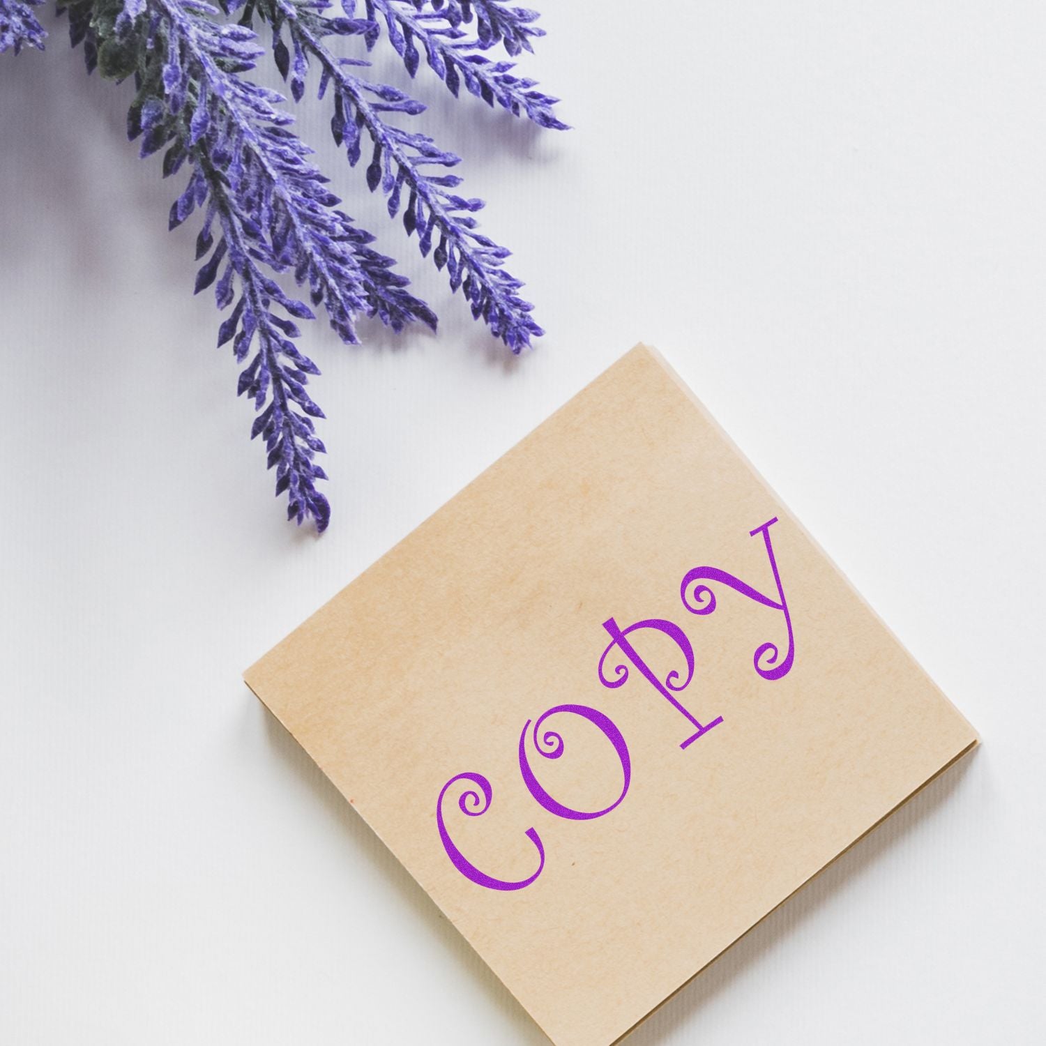 Beige kraft greeting card with purple decorative numerals and a sprig of purple lavender on a white background seasonal, flat lay
