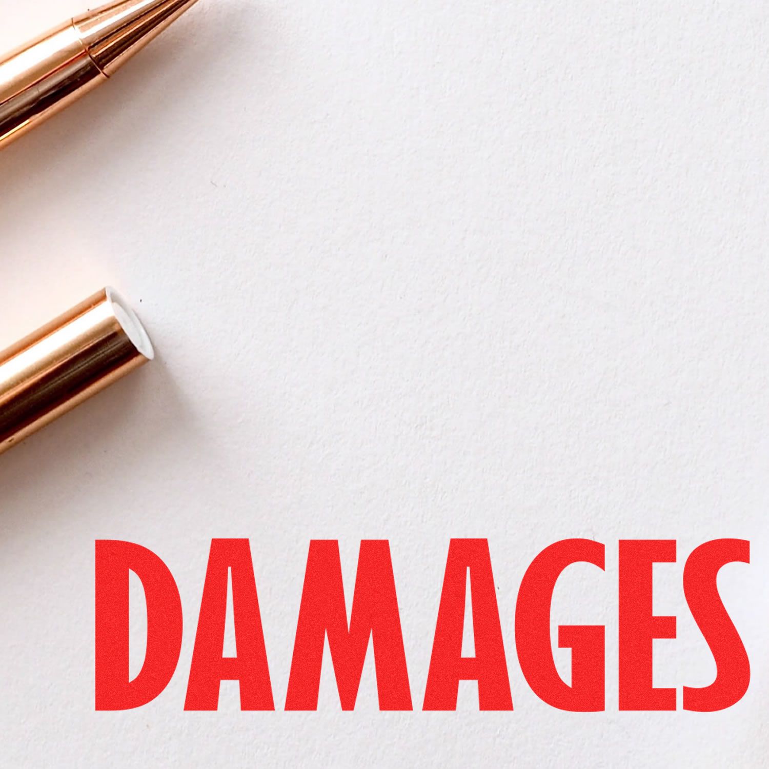 Close-up drafting tools and bold DAMAGES text, representing legal damage claims and liability for personal injury lawsuits and court compensation.