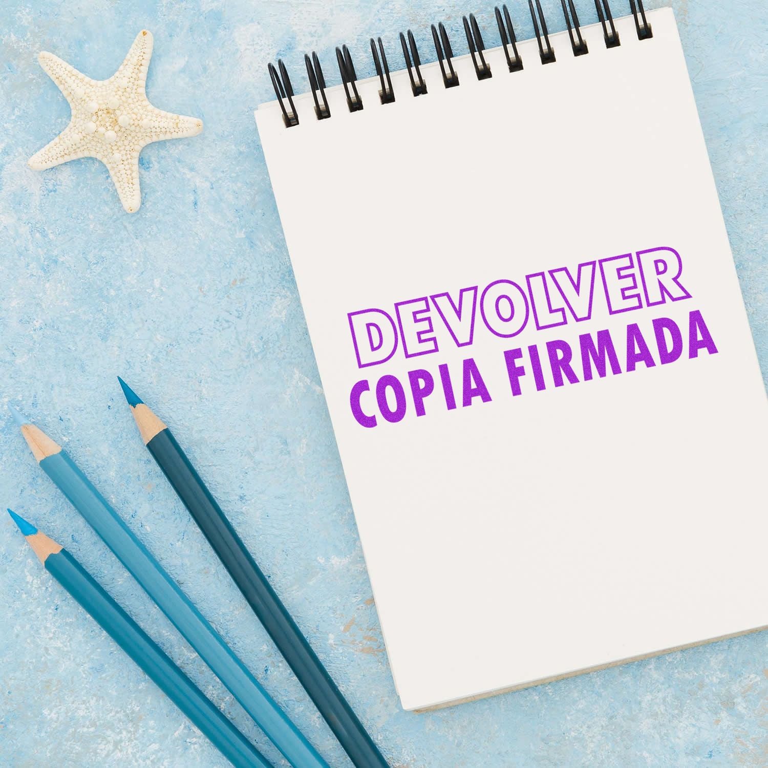 Notebook Devolver Copia Firmada with pencils and starfish on a blue beach backgroundtemplate for returning signed copy