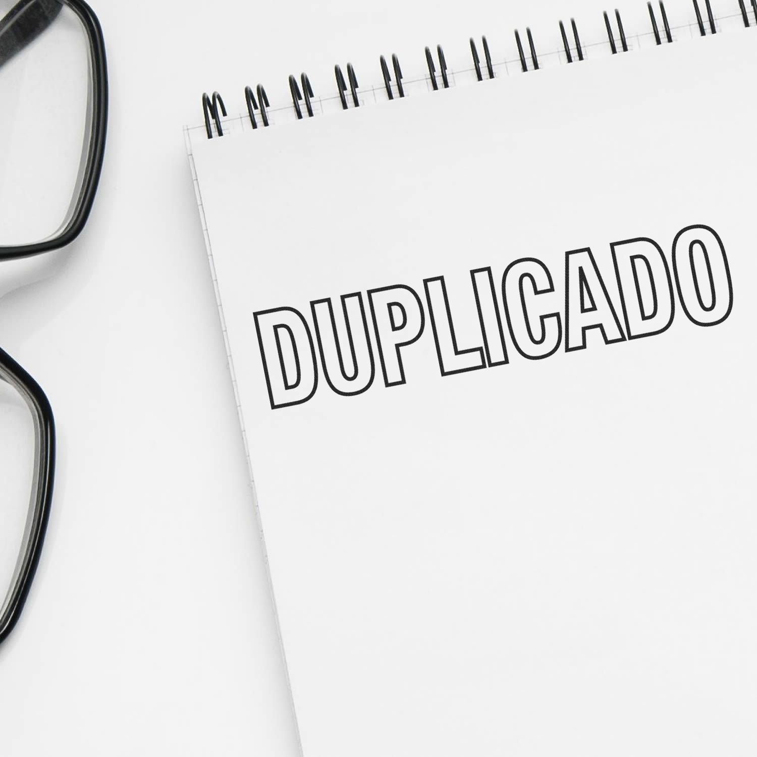 Duplicado document concept: notebook page labeled DUPLICADO with glasses, illustrating copy verification and records.