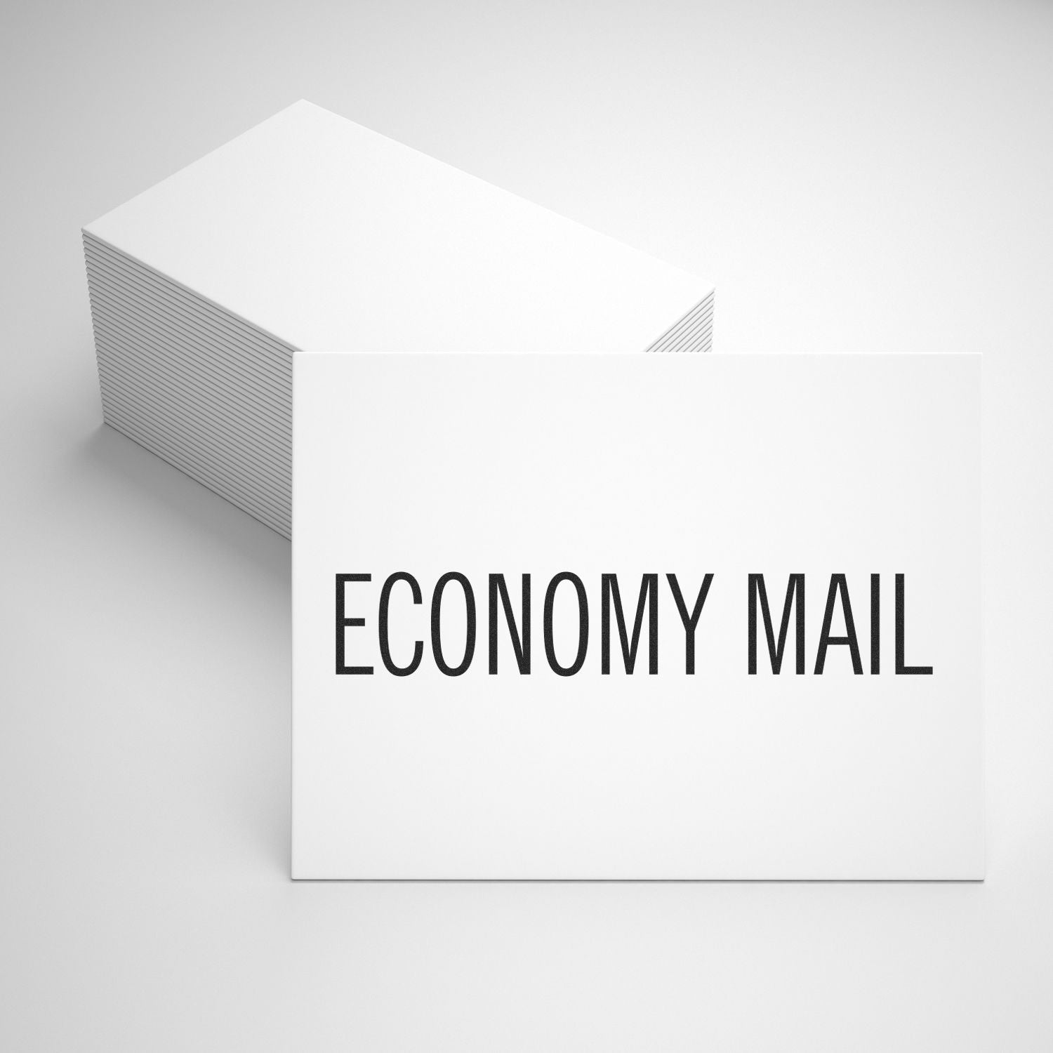 Stack of white economy mail envelopes with ECONOMY MAIL text on the front.