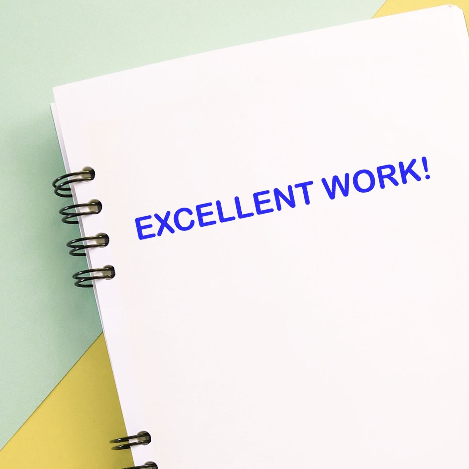 Notebook page with bold blue EXCELLENT WORK! text, celebrating achievements and boosting student or employee motivation.