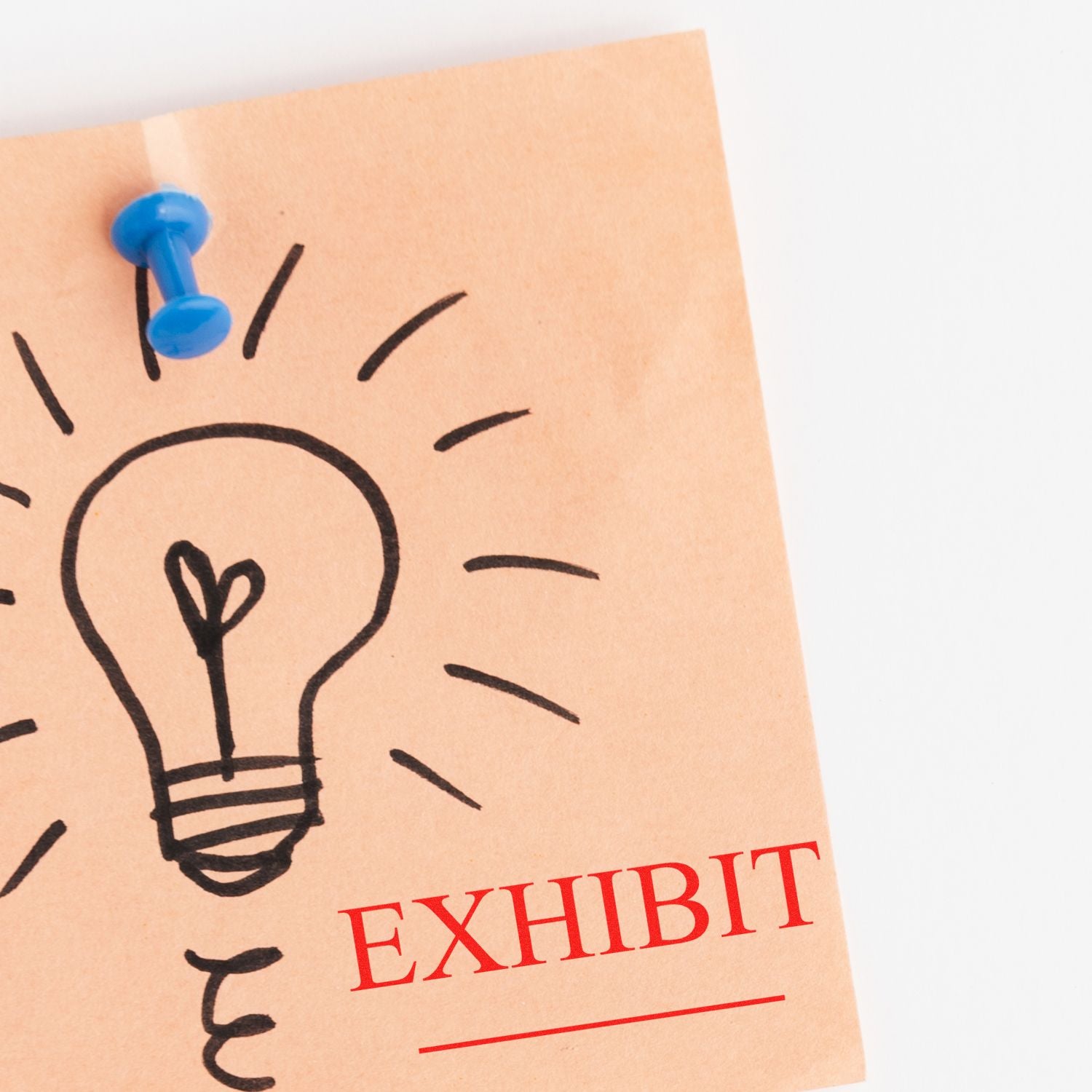 Close-up of Exhibit title card with blue pushpins and hand-drawn lightbulb sketch, promoting creative ideas and signage.