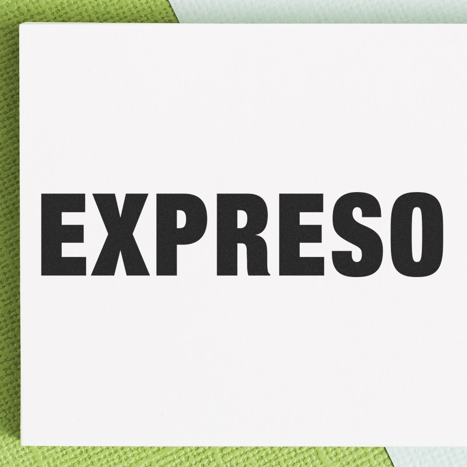 Black EXPRESO text on a white card over a green textured background.