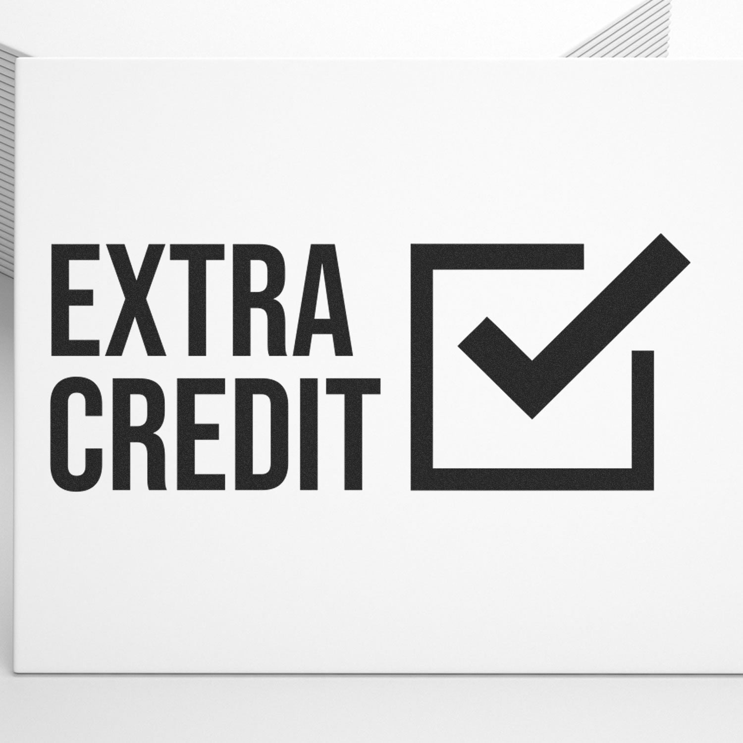 Extra Credit logo on a wall featuring the words EXTRA CREDIT with a bold checkmark icon in a square.