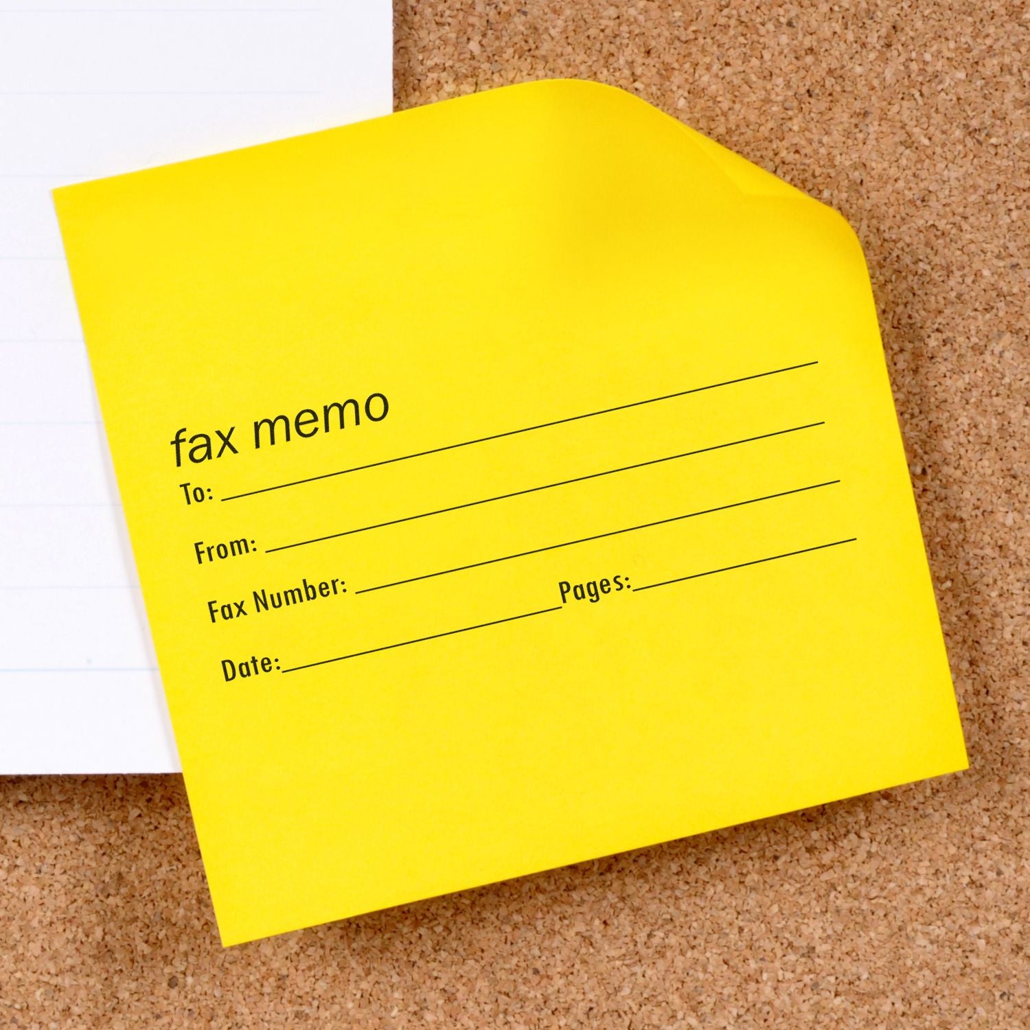 Yellow fax memo form on corkboard, office stationery close-up.