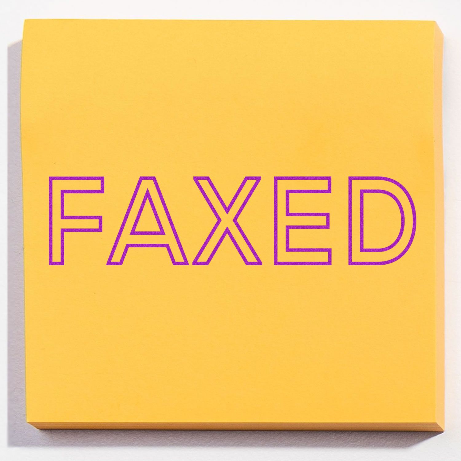Yellow book cover with bold purple outlined text 'FAXED', showcasing minimalist typography graphic design for branding on a clean square canvas.