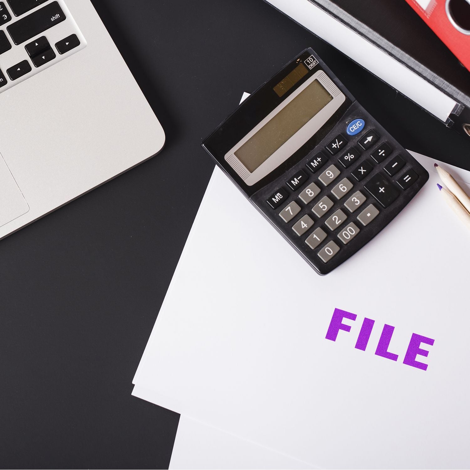 Financial calculator on paperwork beside a laptop, illustrating budgeting, accounting, and tax calculation for business.
