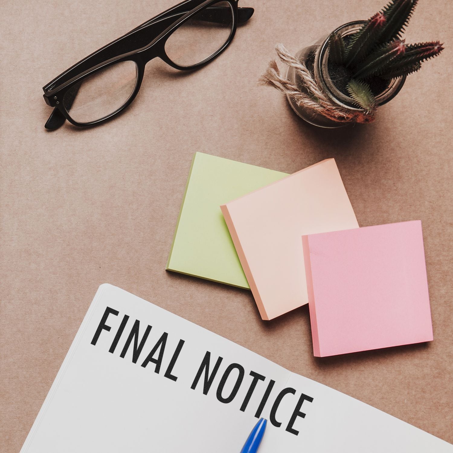 Final notice document on desk with eyeglasses, colorful notes and featherbusiness communication and deadline reminder.