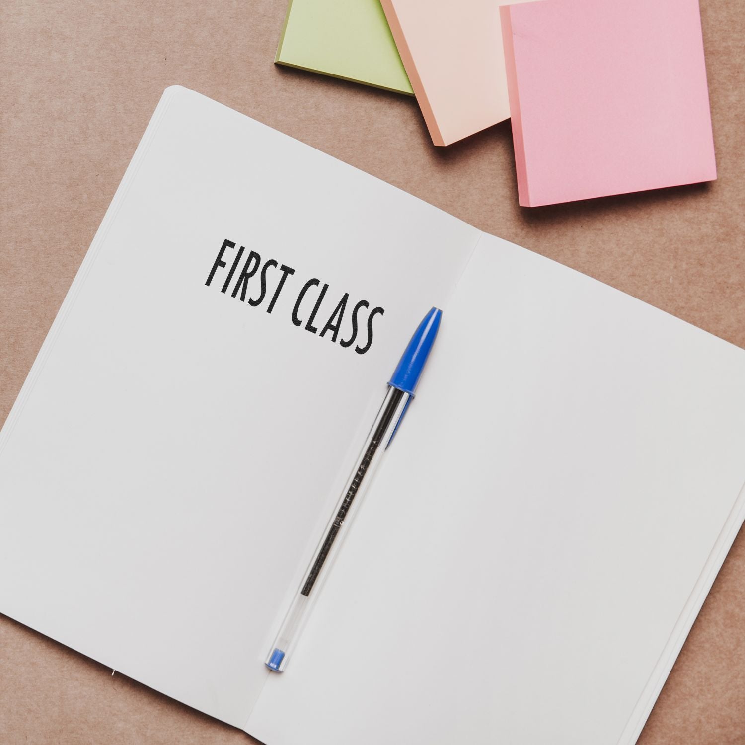 First class notebook and blue pen on desk, symbolizing premium education, study notes, and productivity planning.