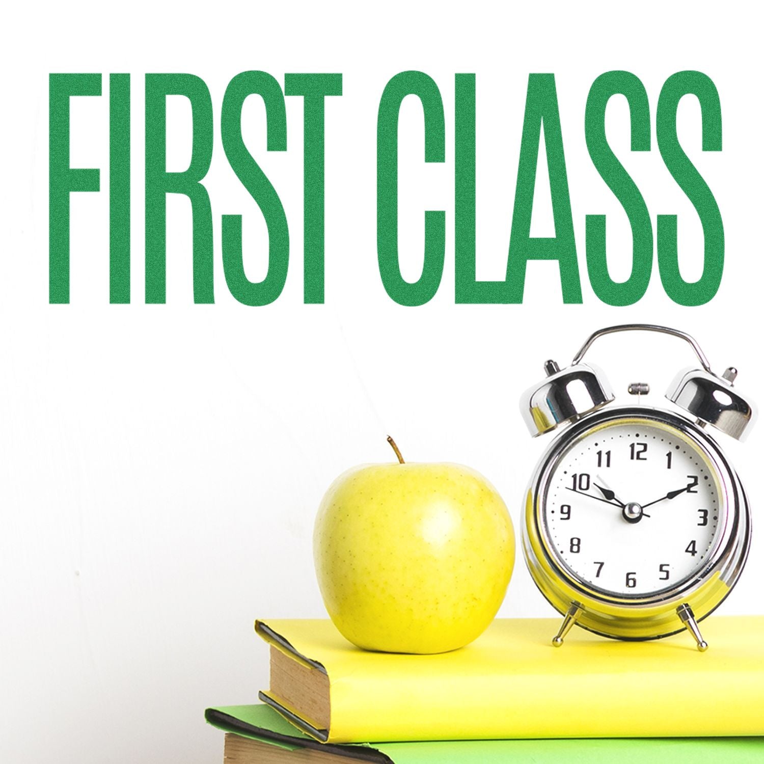 First class study concept: green FIRST CLASS text above an apple and alarm clock on books for time-management education.