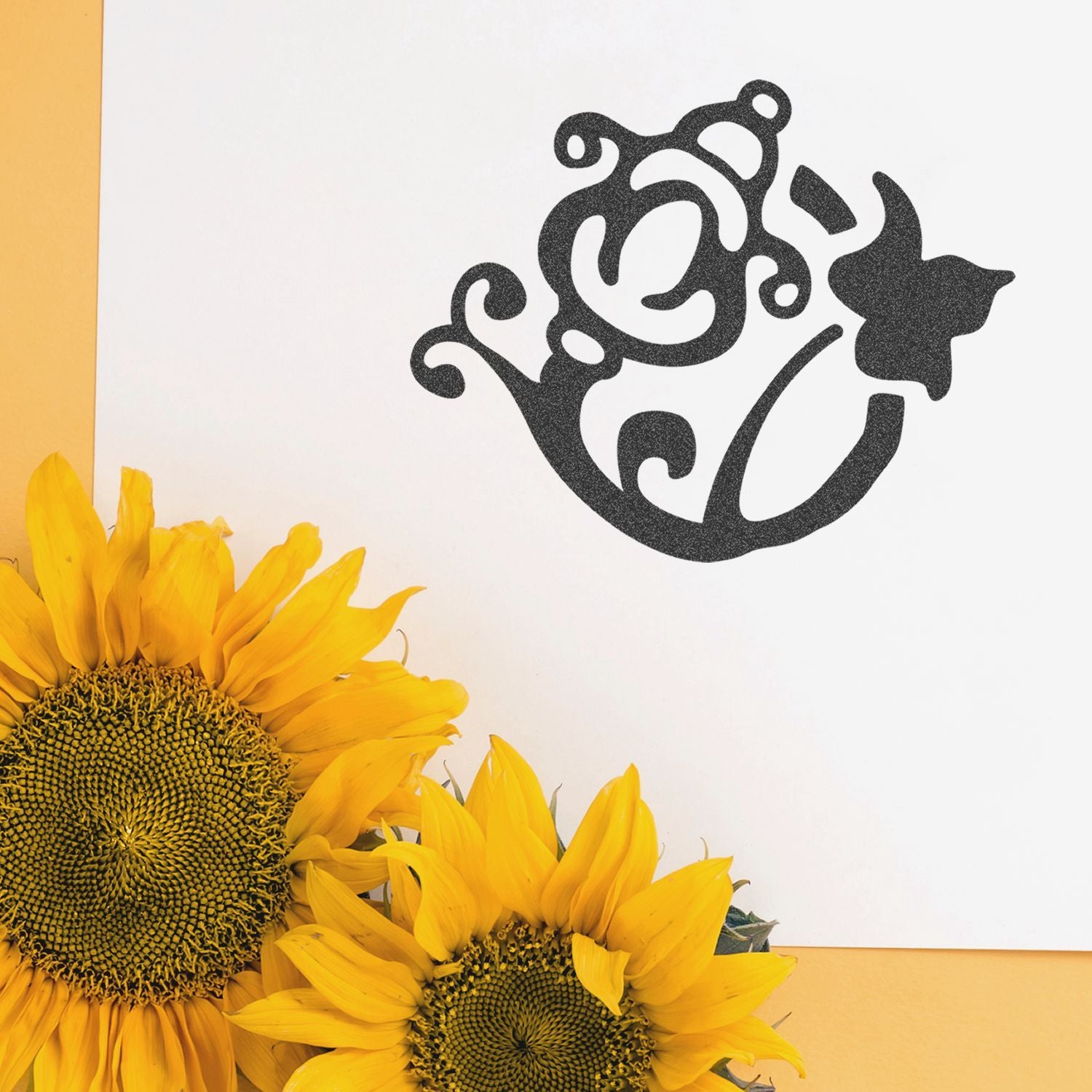 Bright yellow sunflowers with a black floral decorative design on a white background.