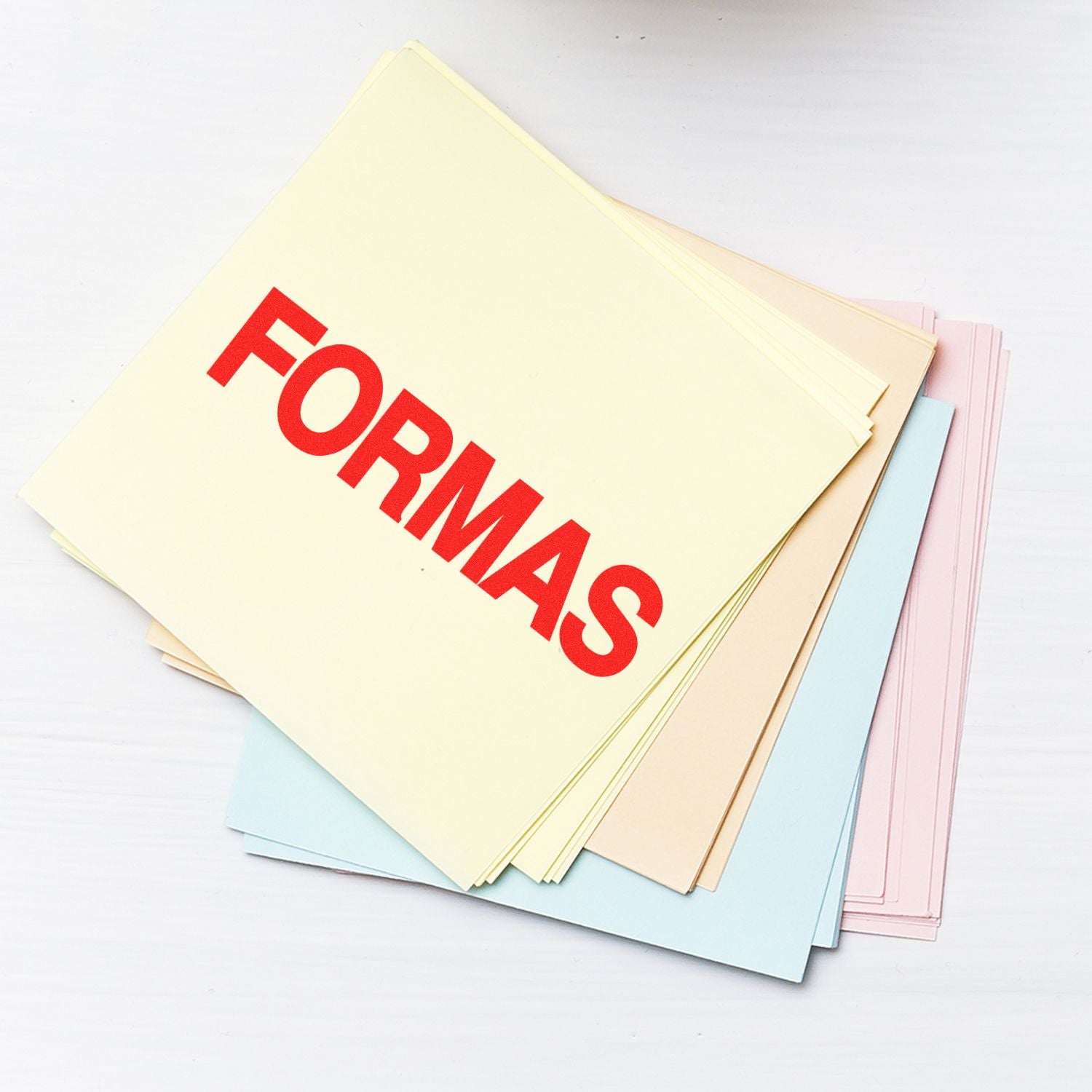 Stack of pastel paper forms folders with bold red FORMAS text on a white background