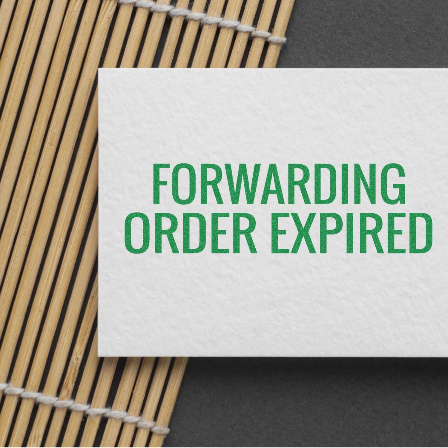 Forwarding order expired notice on a white card with green FORWARDING ORDER EXPIRED text over a woven bamboo mat.