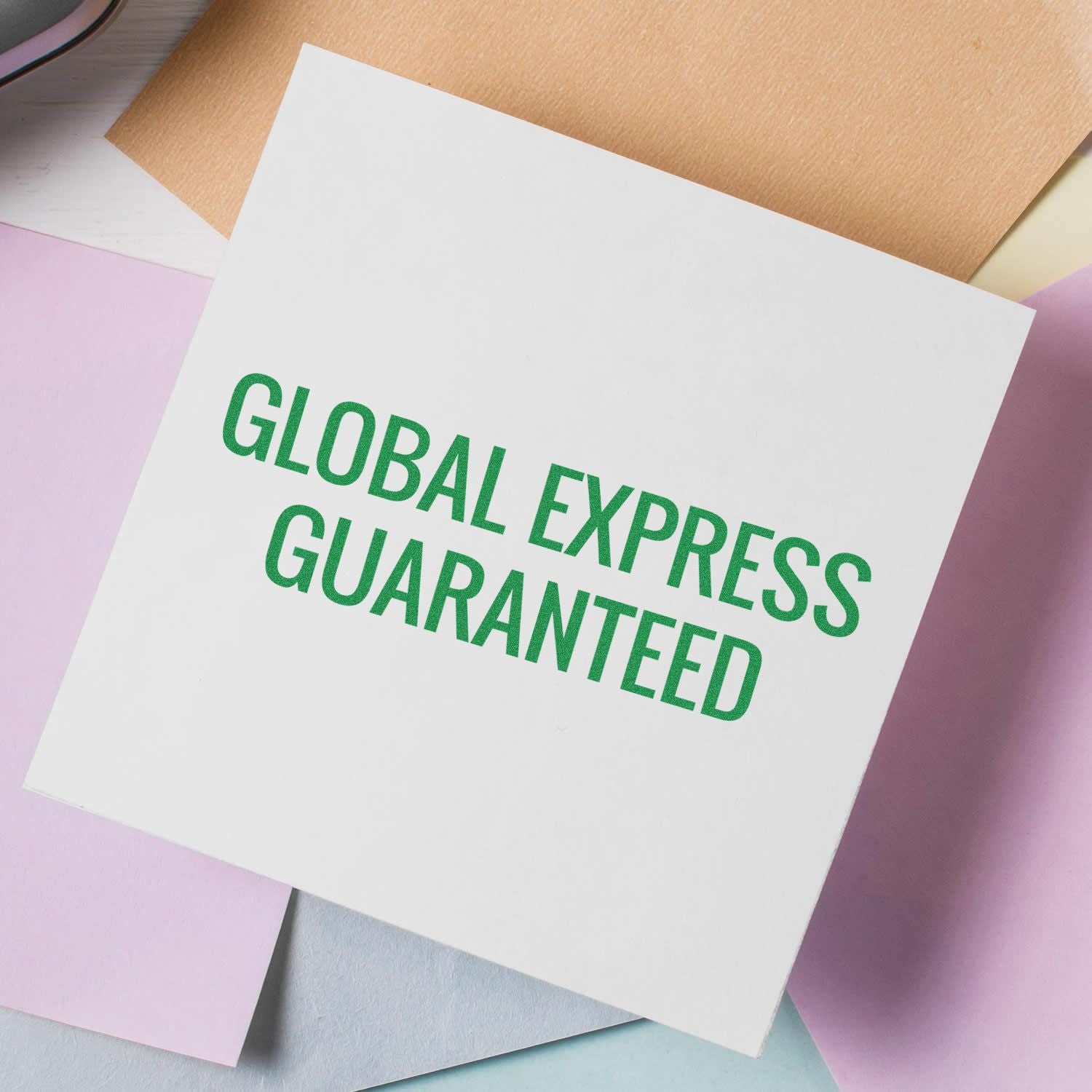 White card with green Global Express Guaranteed text on pastel paper background.