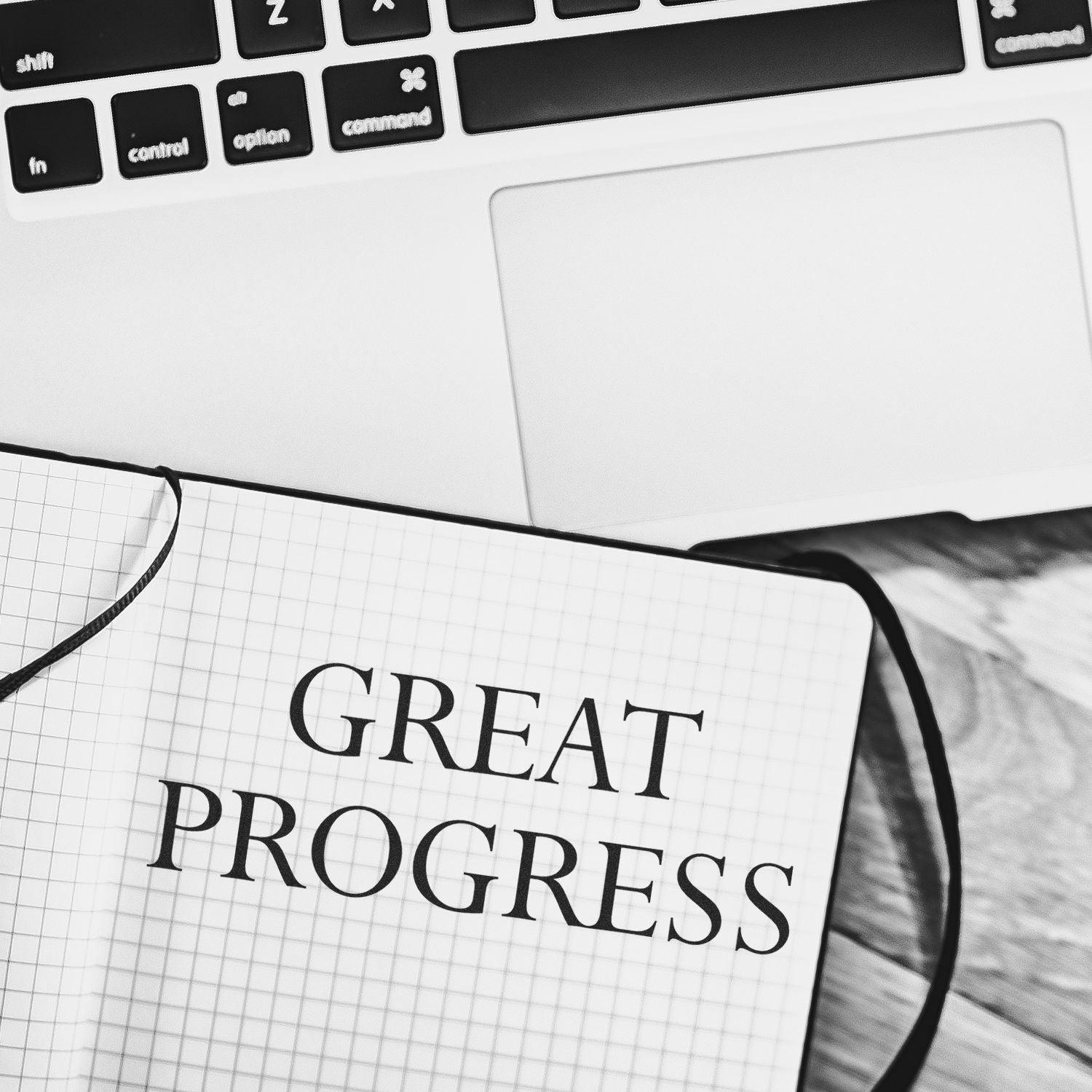 Notebook and calculator on desk with Great Progress text, symbolizing goal setting and productivity