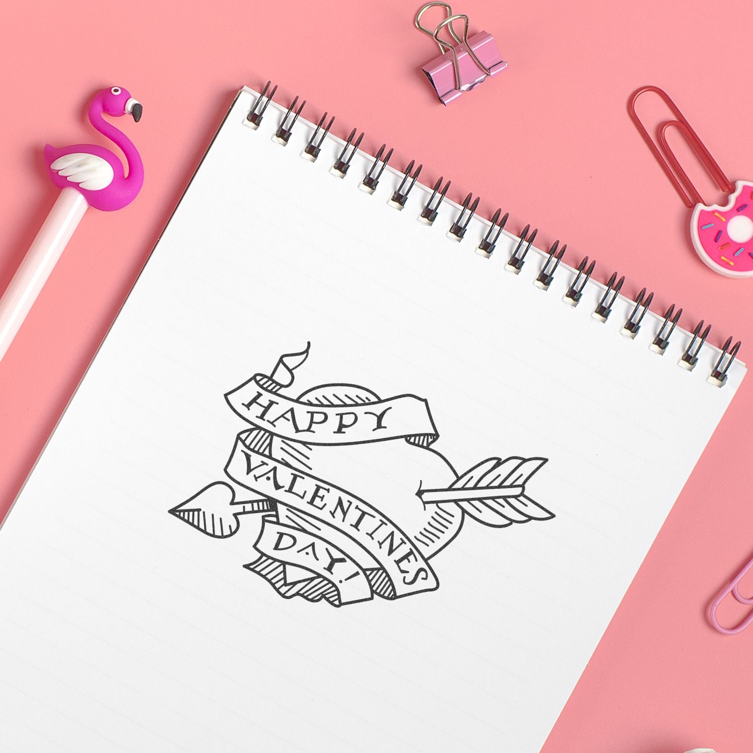 Pink Valentines Day notebook with Happy Valentines Day doodle, flamingo pen, and cute stationery on pastel pink background.