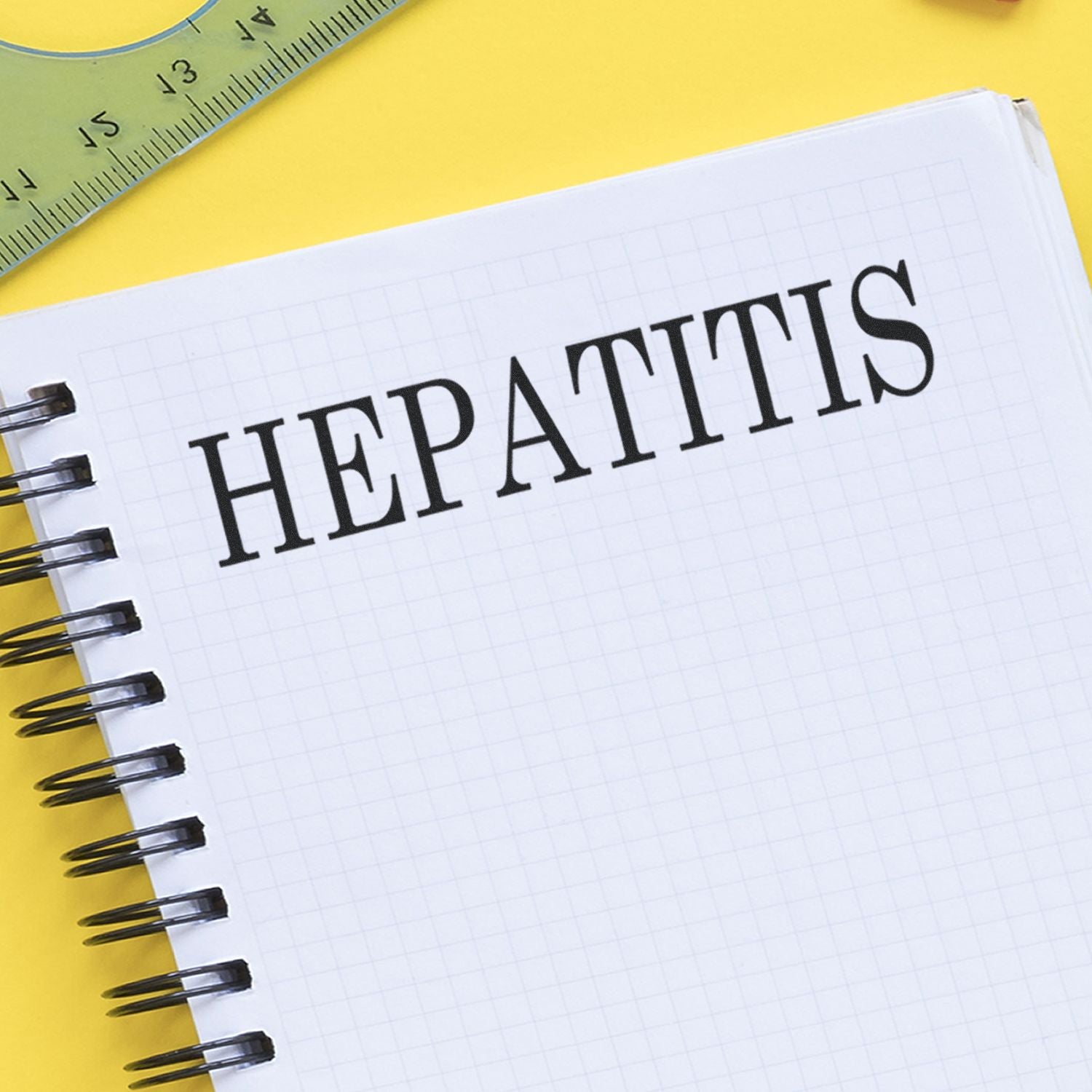 Close-up of notebook page with the word HEPATITIS, used to highlight liver disease awareness for medical education.