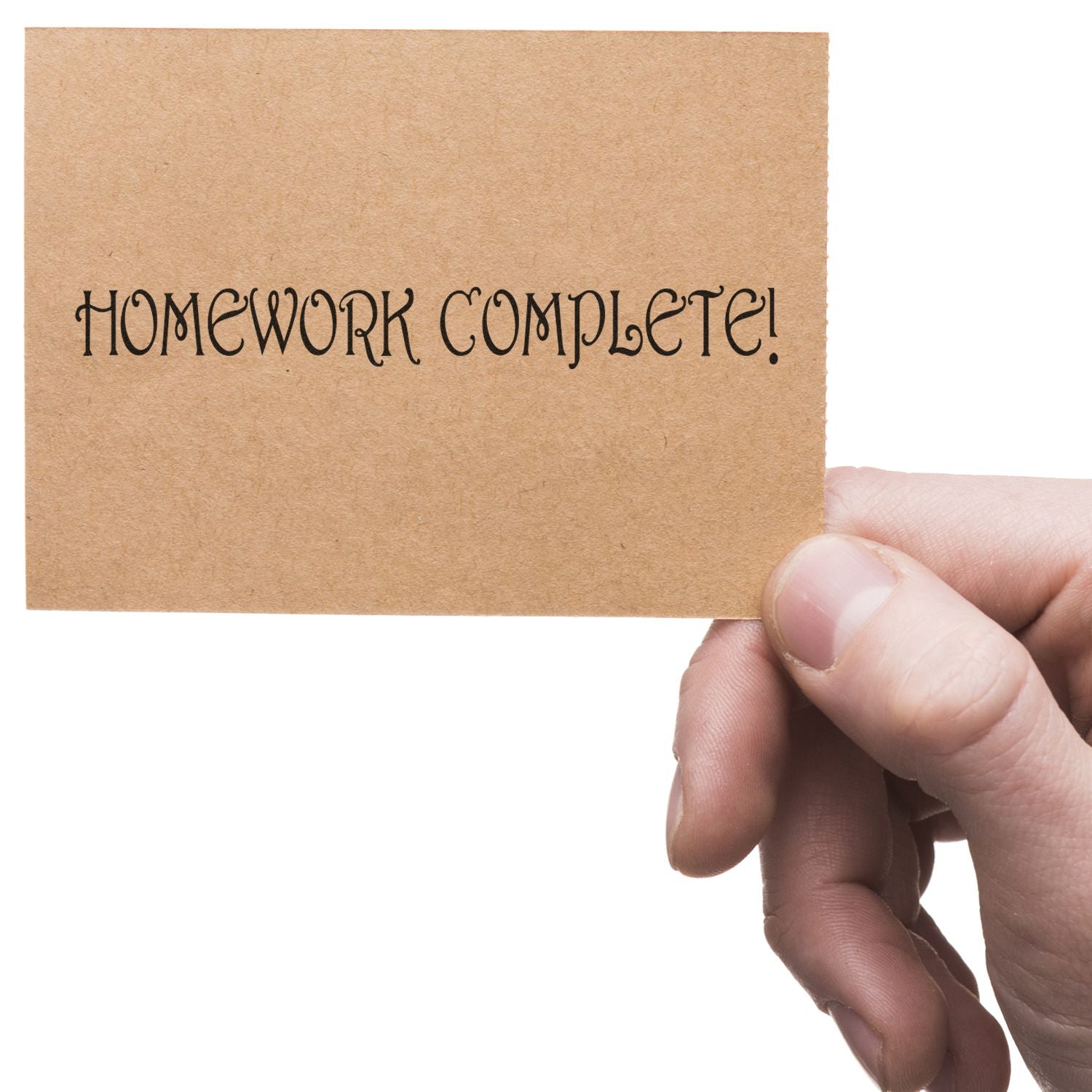 Hand holds a note reading Homework Complete! celebrating school homework completion and finishing assignments.