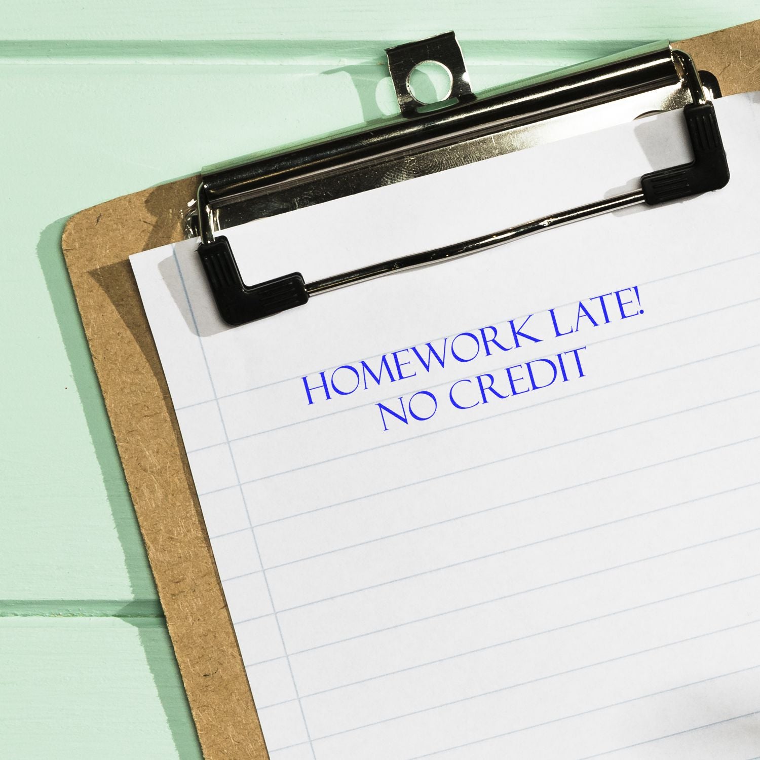 Clipboard note stating Homework Late! No Creditwarning about late assignments and grading policy.