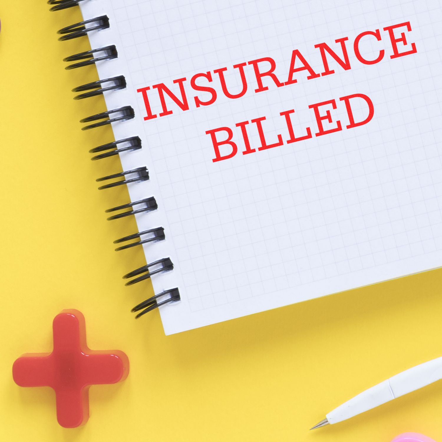 Notebook page reading Insurance Billed with red medical cross, illustrating healthcare billing and insurance claims