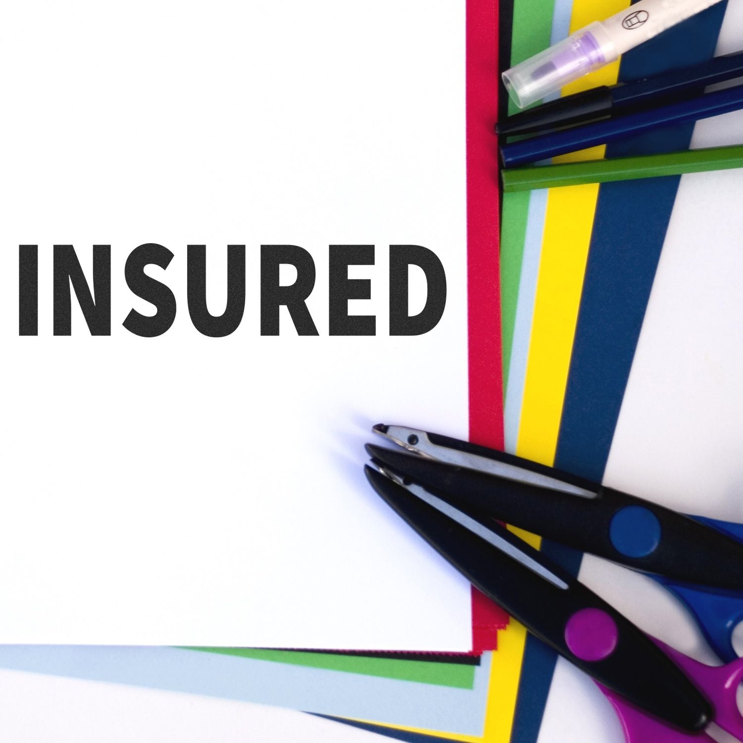 INSURED title over colorful paper and scissors, highlighting protected shipping or insurance for documents or crafts.