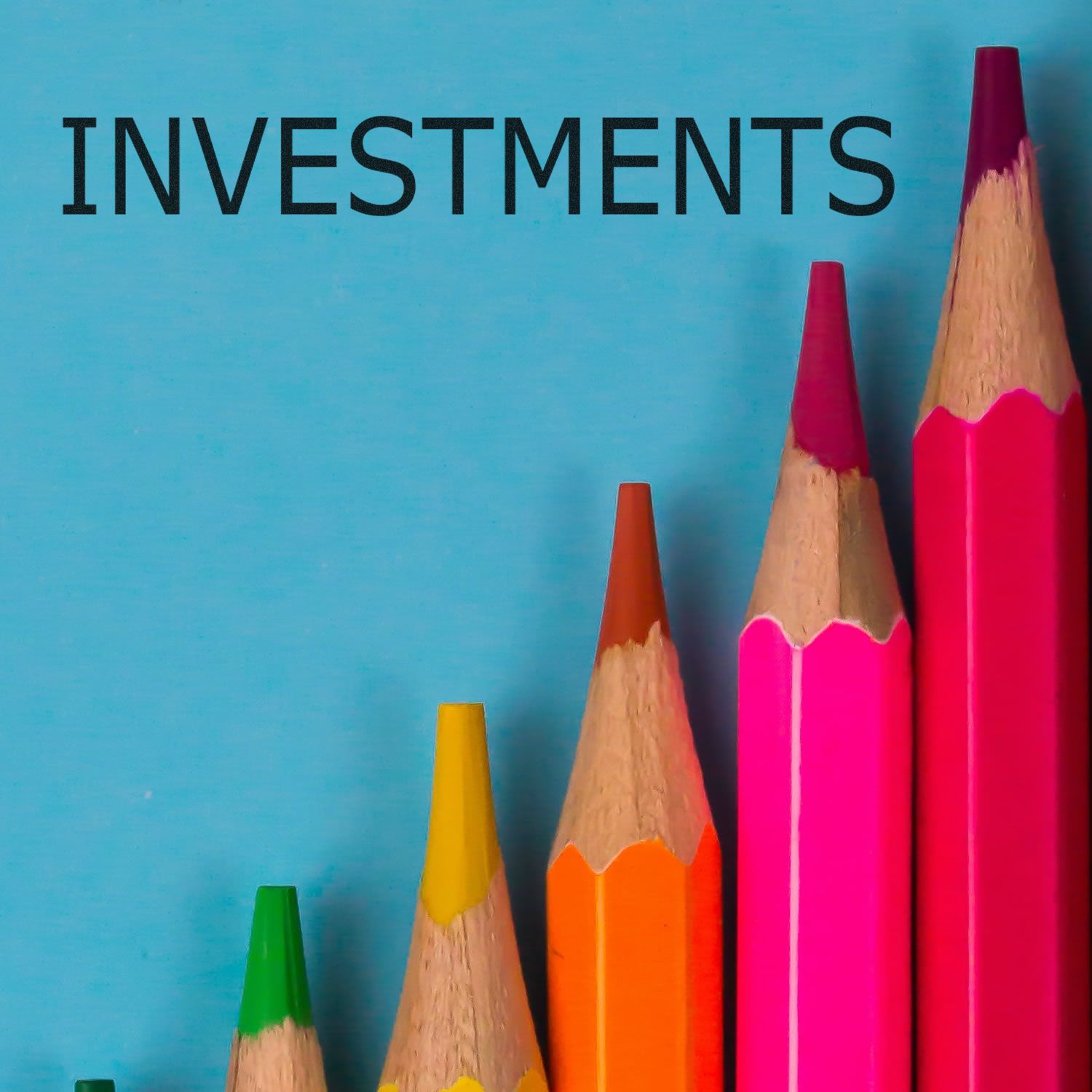 Investments concept with colorful pencils and the word INVESTMENTS on a blue background for finance education