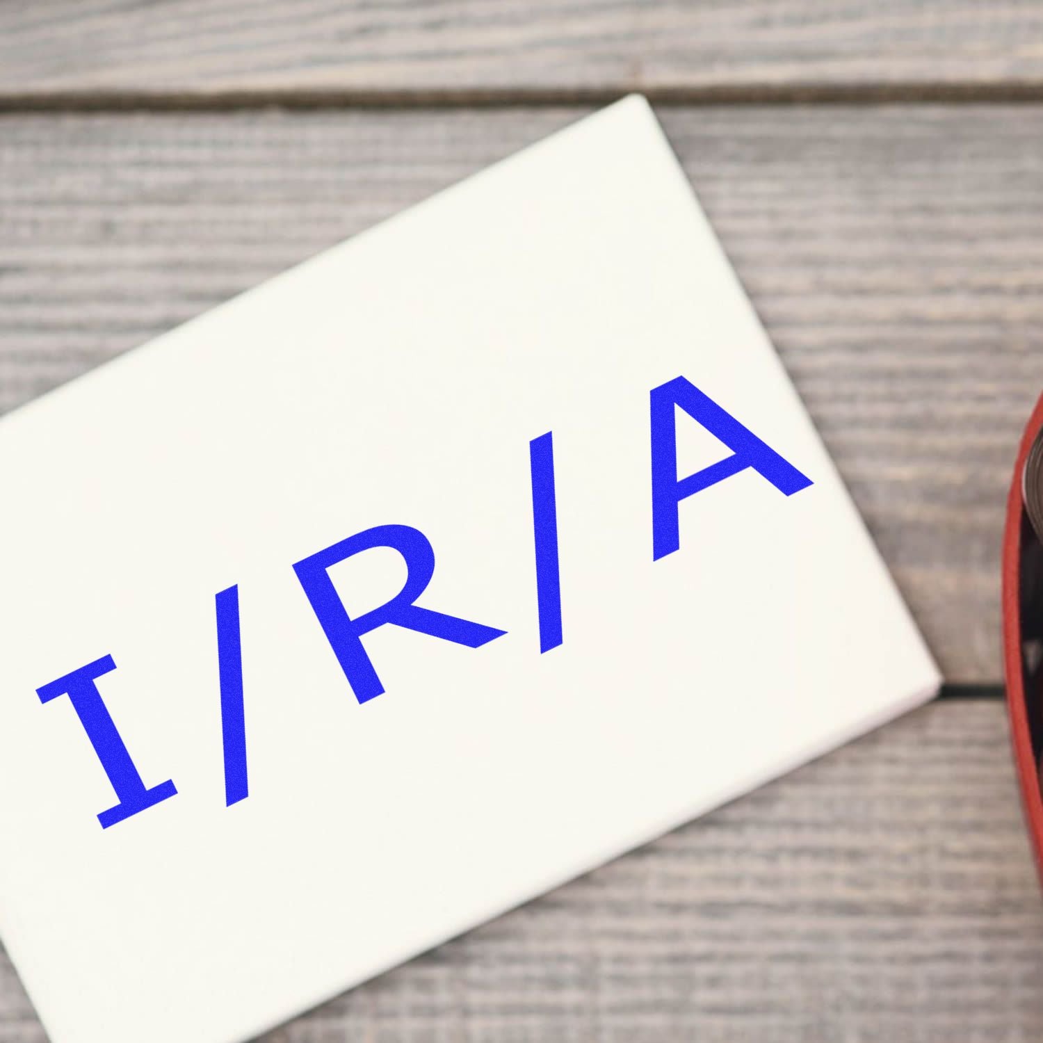 Close-up of TRIAL promotion text on a white card, signaling a trial offer for advertising on a wooden tabletop.