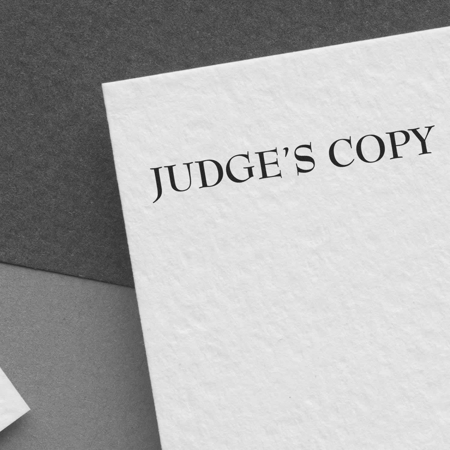 Close-up of a textured paper card labeled Judges Copy, used for legal document proofs and court records.