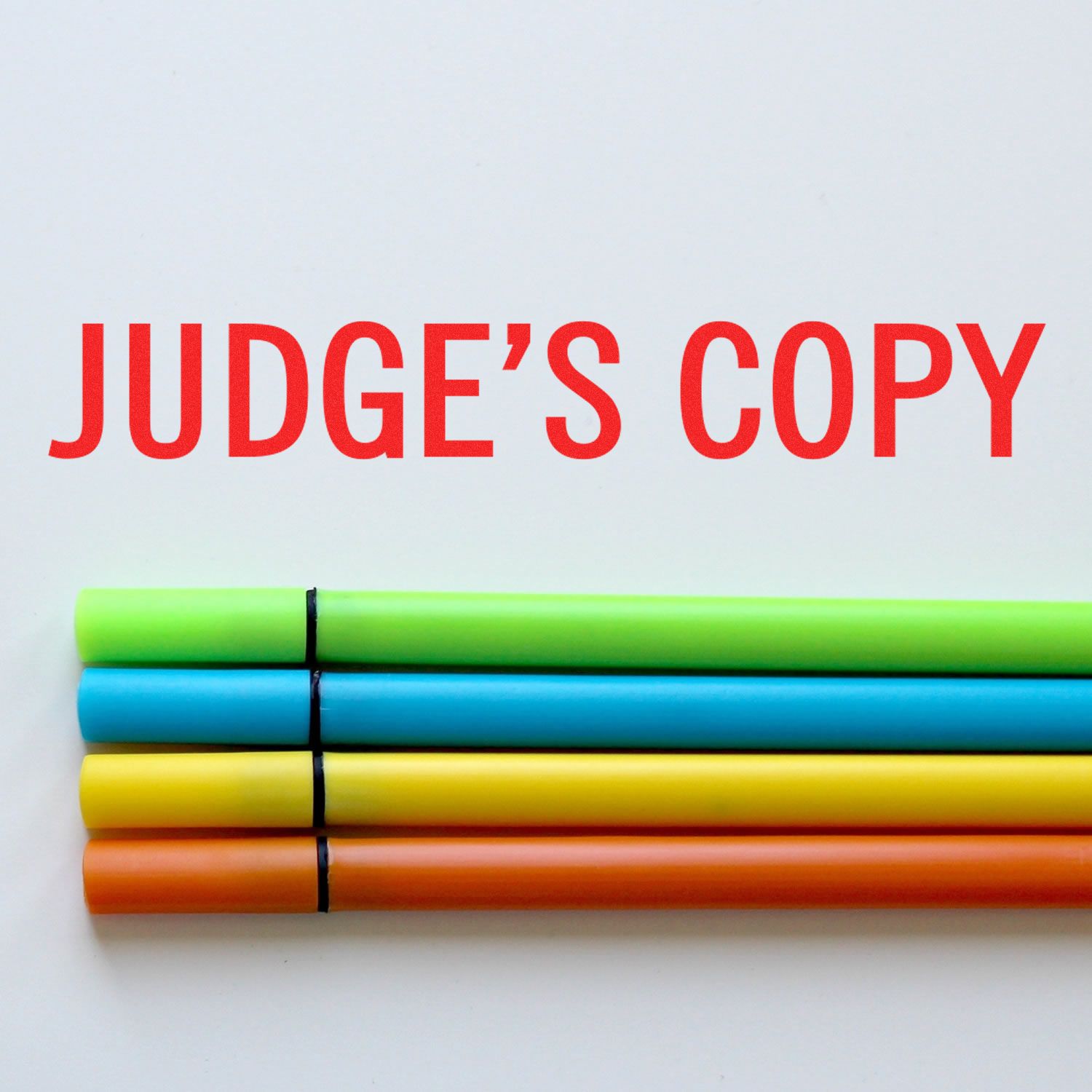 Colorful crayons under bold red text JUDGES COPY, symbolizing a legal document review copy for judges