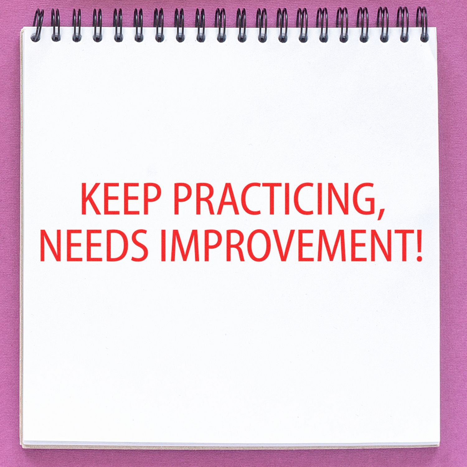 Notebook page with motivational text Keep Practicing, Needs Improvement! encouraging growth through continuous practice.