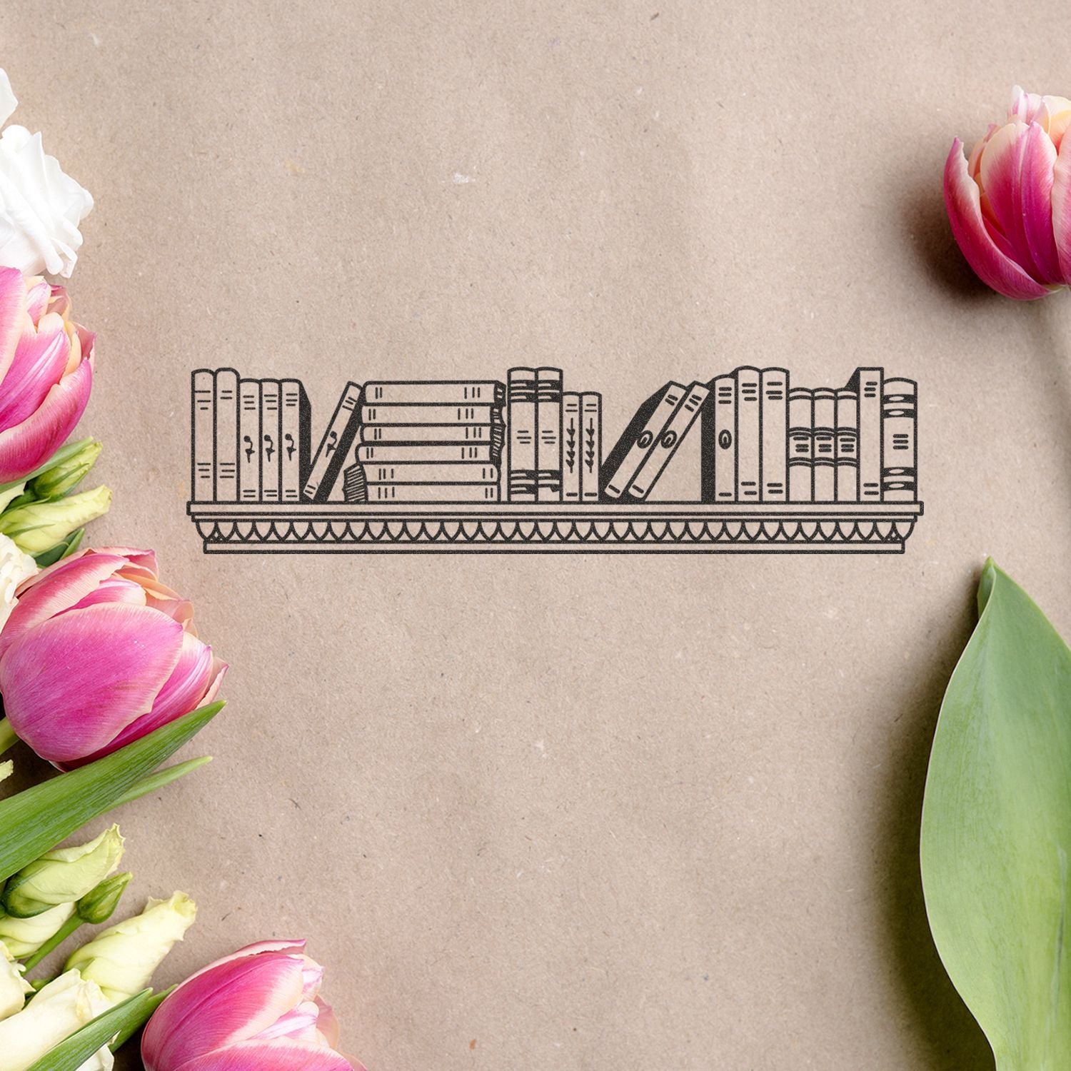 Decorative bookshelf illustration on kraft paper surrounded by pink and white tulips, floral flat lay background.