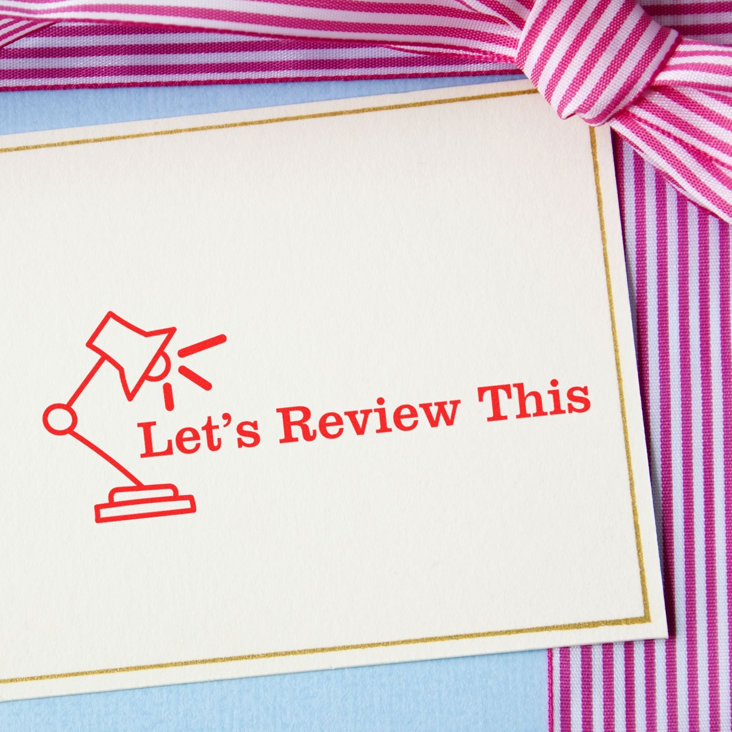 Lets Review This educational review card with red arrow icon on striped fabric background, prompting study revision