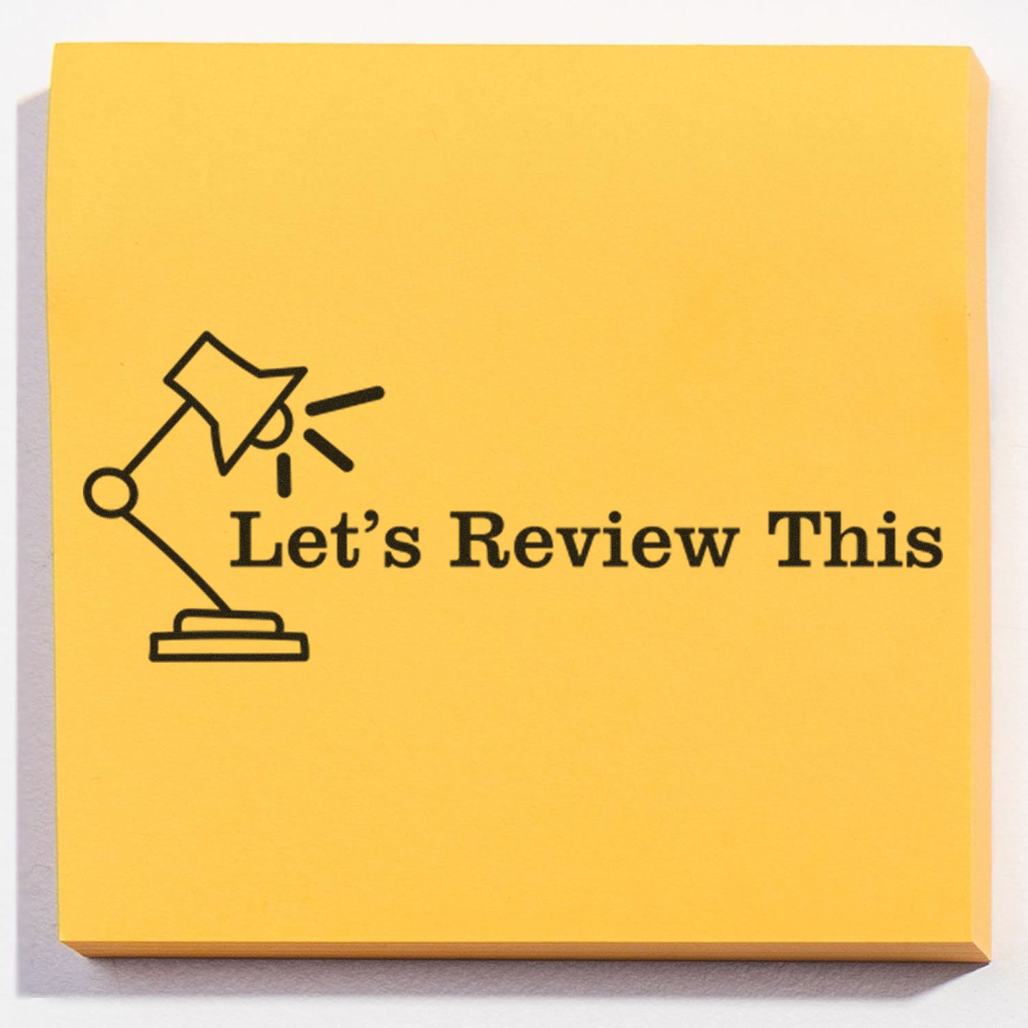 Yellow sticky note with Lets Review This text and desk lamp icon, ideal for feedback, discussion, and review reminders.
