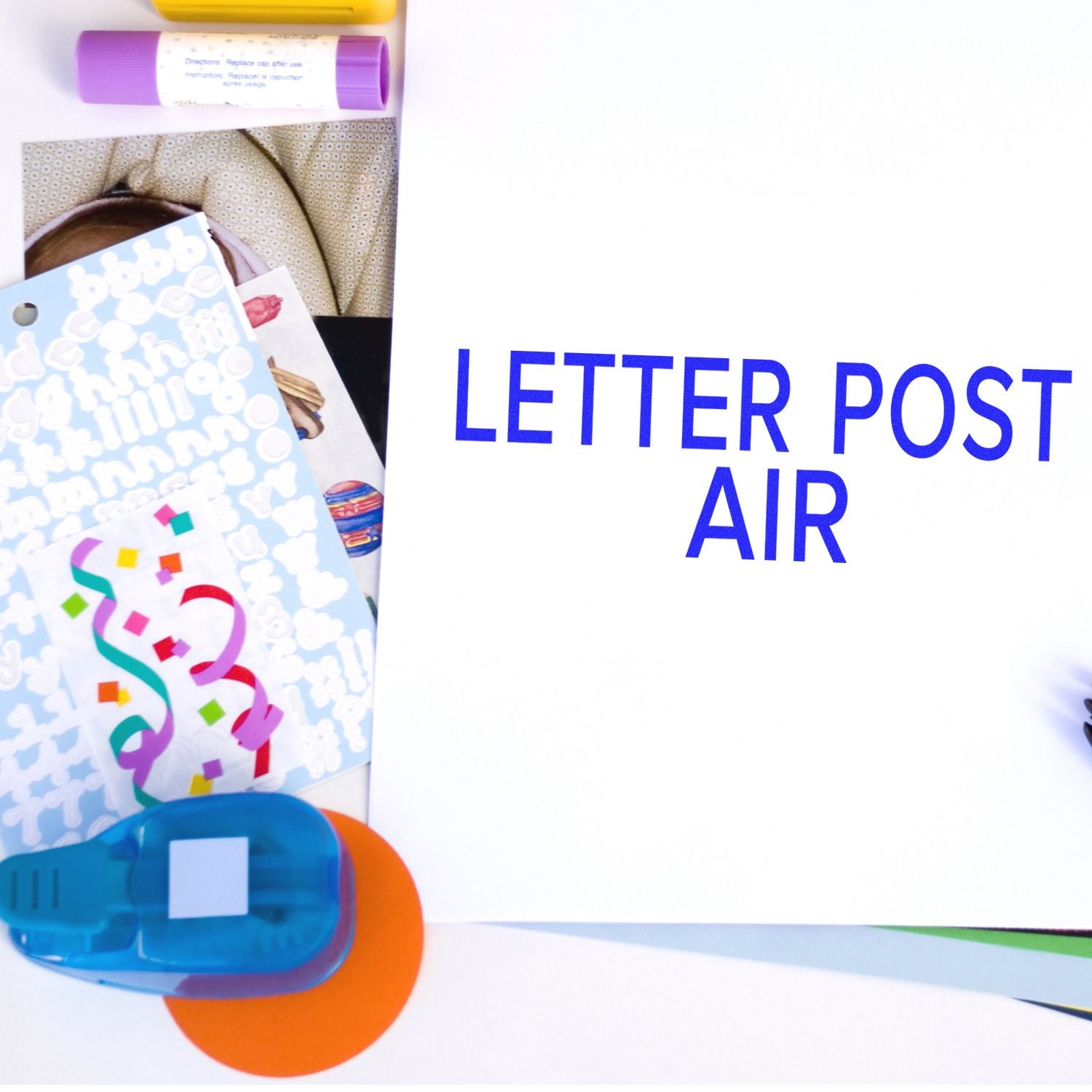 Letter Post Air concept with mail envelope, colorful stationery supplies, and blue text for international air shipping service.