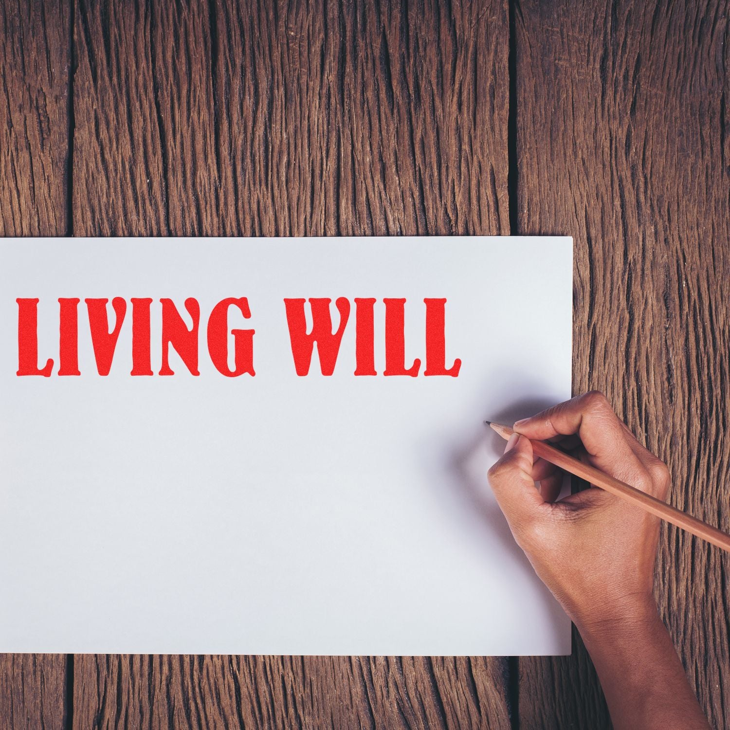 Hand writes Living Will on a blank page with a pencil, promoting advance directive and end-of-life planning.